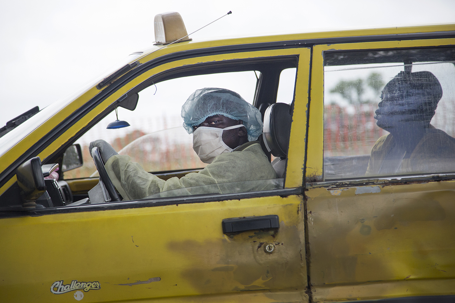 A taxi driver brings a sick woman to an Ebola clinic in Monrovia on Sept. 4.