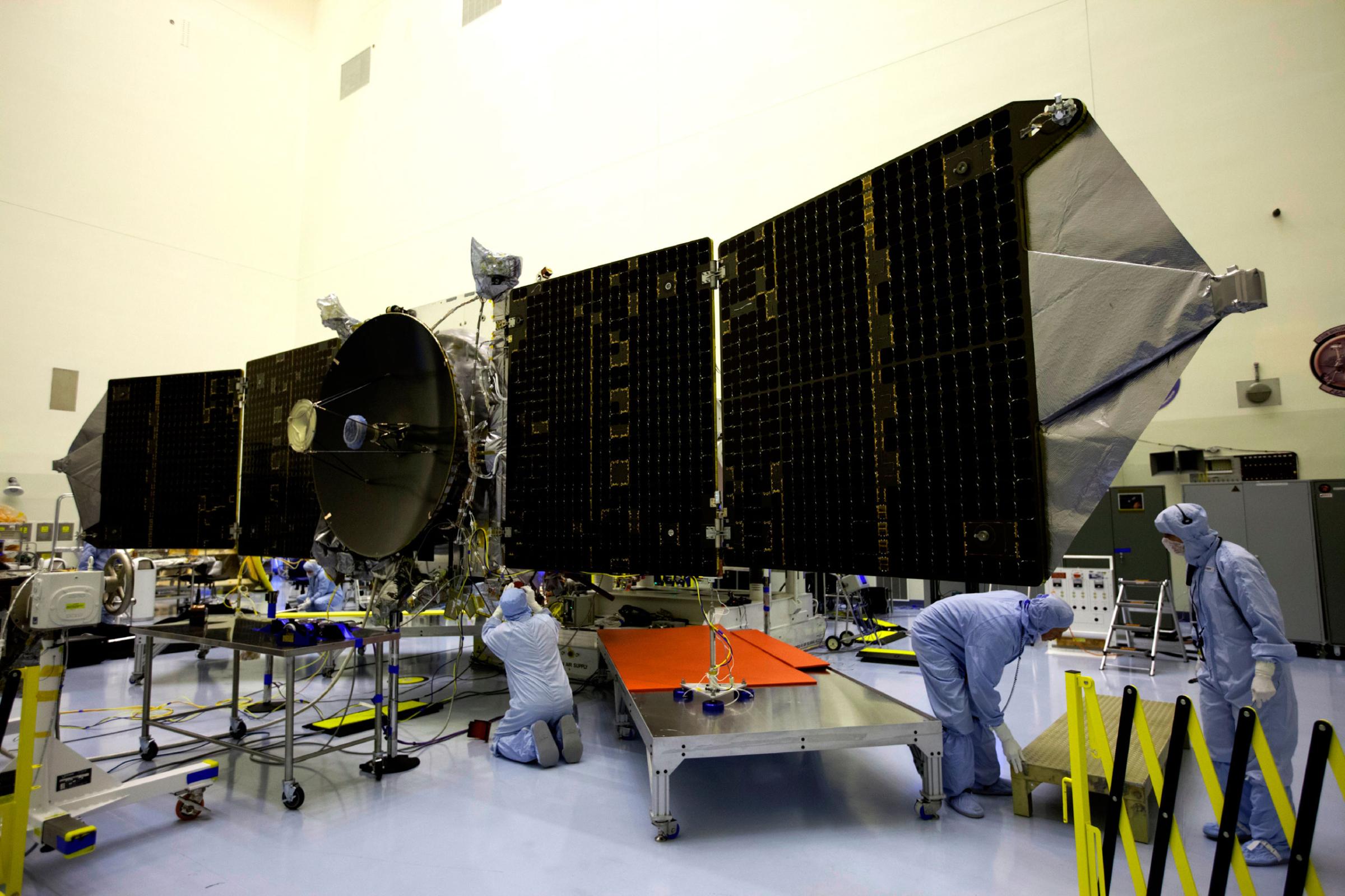 Engineers and technicians test deploy the twin solar arrays on the Mars Atmosphere and Volatile Evolution, or MAVEN, spacecraft at the Payload Hazardous Servicing Facility at NASA's Kennedy Space Center in Florida on Sept. 23, 2013.