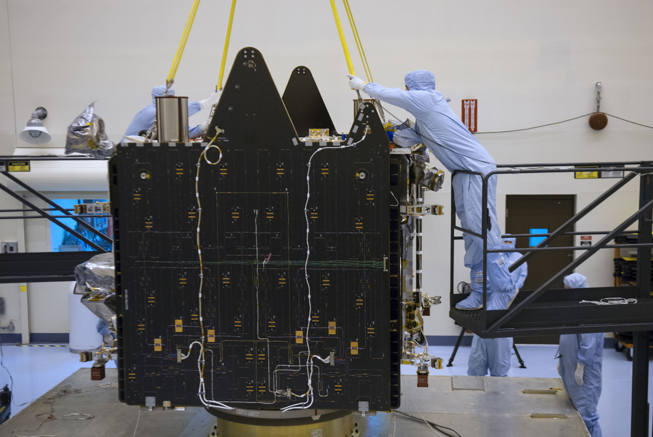 An engineer positions a sling on the MAVEN spacecraft inside the Payload Hazardous Servicing Facility. MAVEN will be prepared inside the facility for its scheduled November launch to Mars.