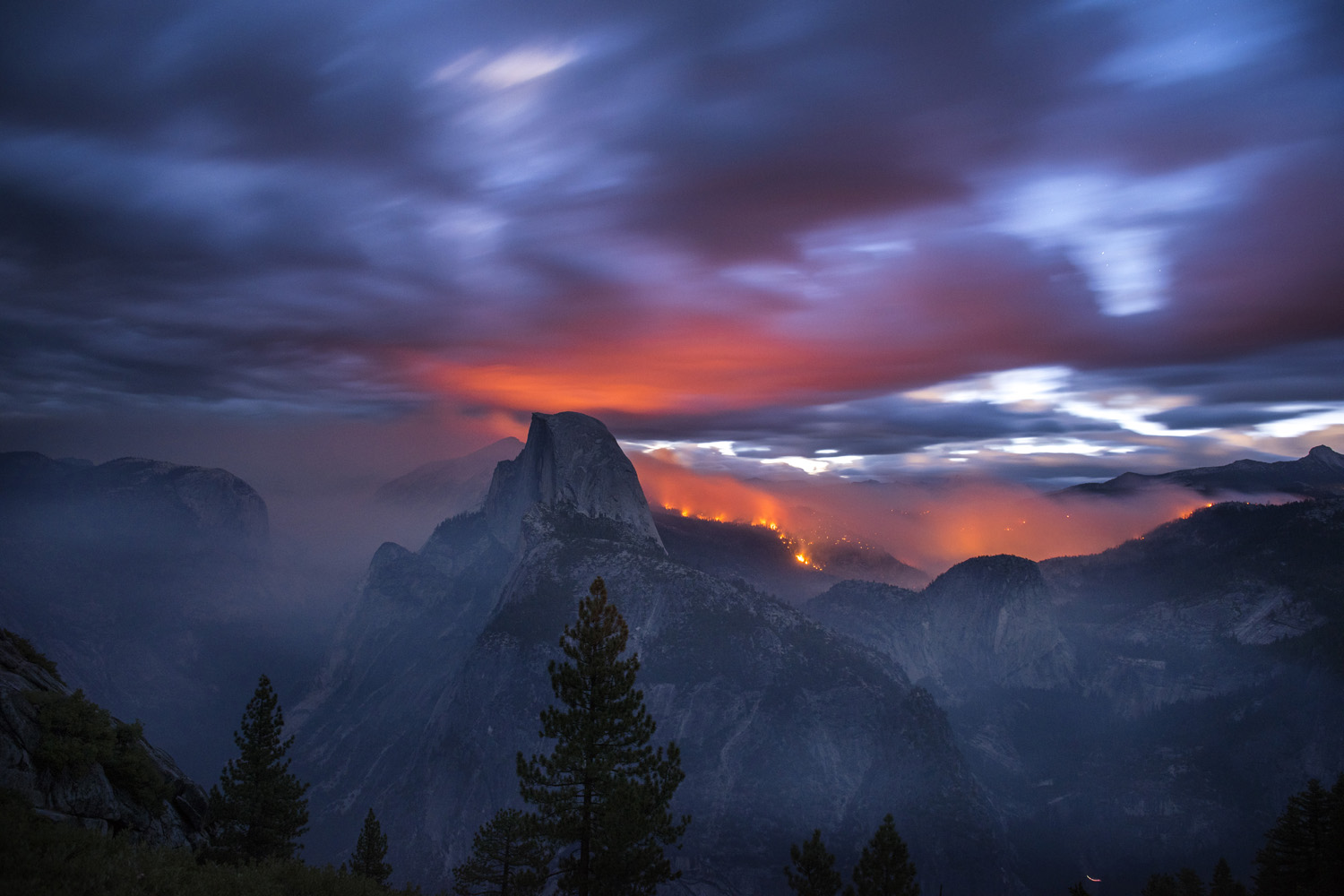 The Meadow Fire burns at dawn near Half Dome in Yosemite National Park early Monday September 8, 2014. As of Wednesday the fire had burned over 4,500 acres and was 10% contained. Long exposure image.