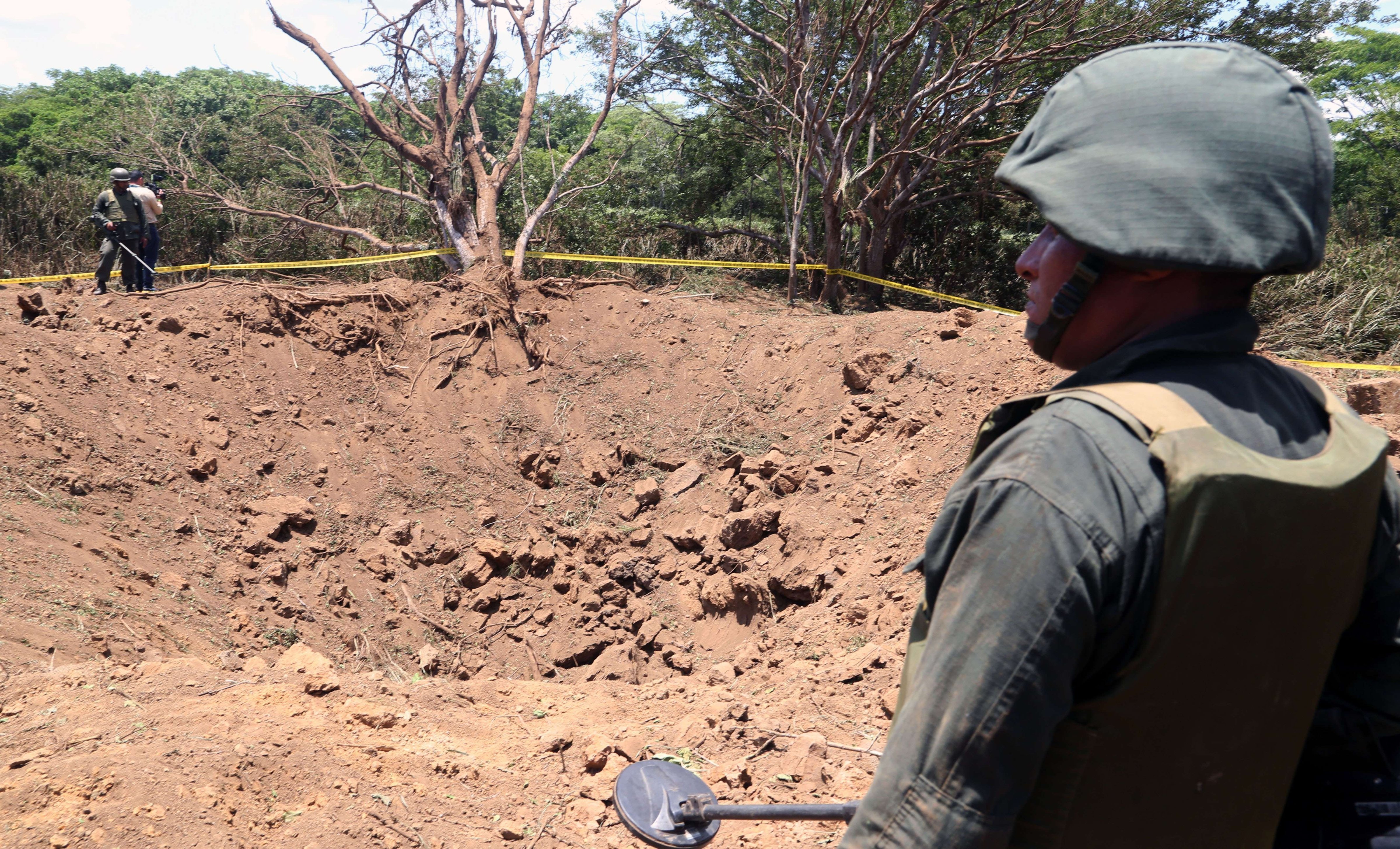 A Nicaraguan soldier checks the site where an alleged meteorite struck on Sept. 7, 2014 in Managua. 