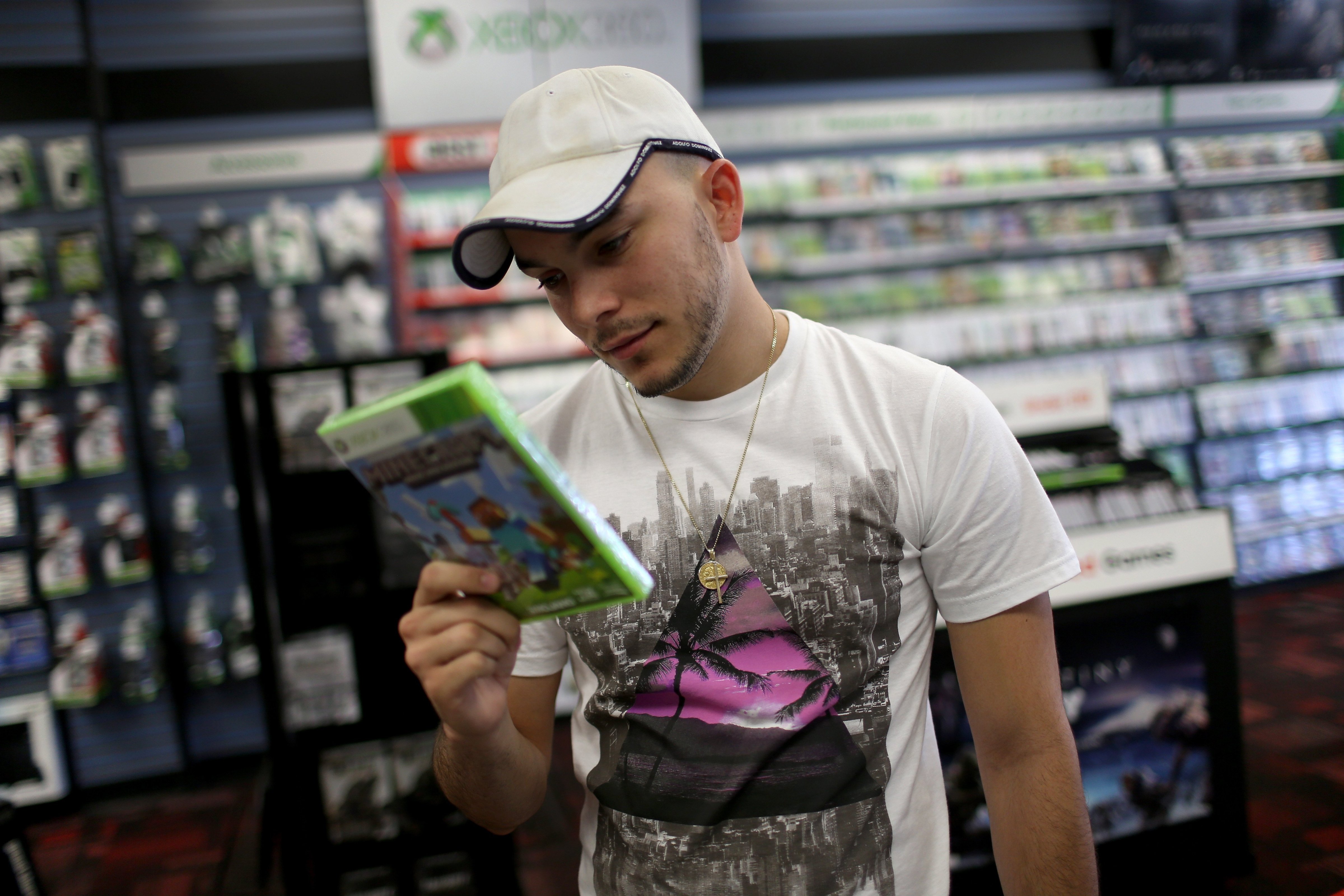 MIAMI, FLORIDA - SEPTEMBER 15: Daniel Llevara checks out the XBox 360 Minecraft game at a GameStop store on Sept. 15, 2014 in Miami. (Joe Raedle—Getty Images)