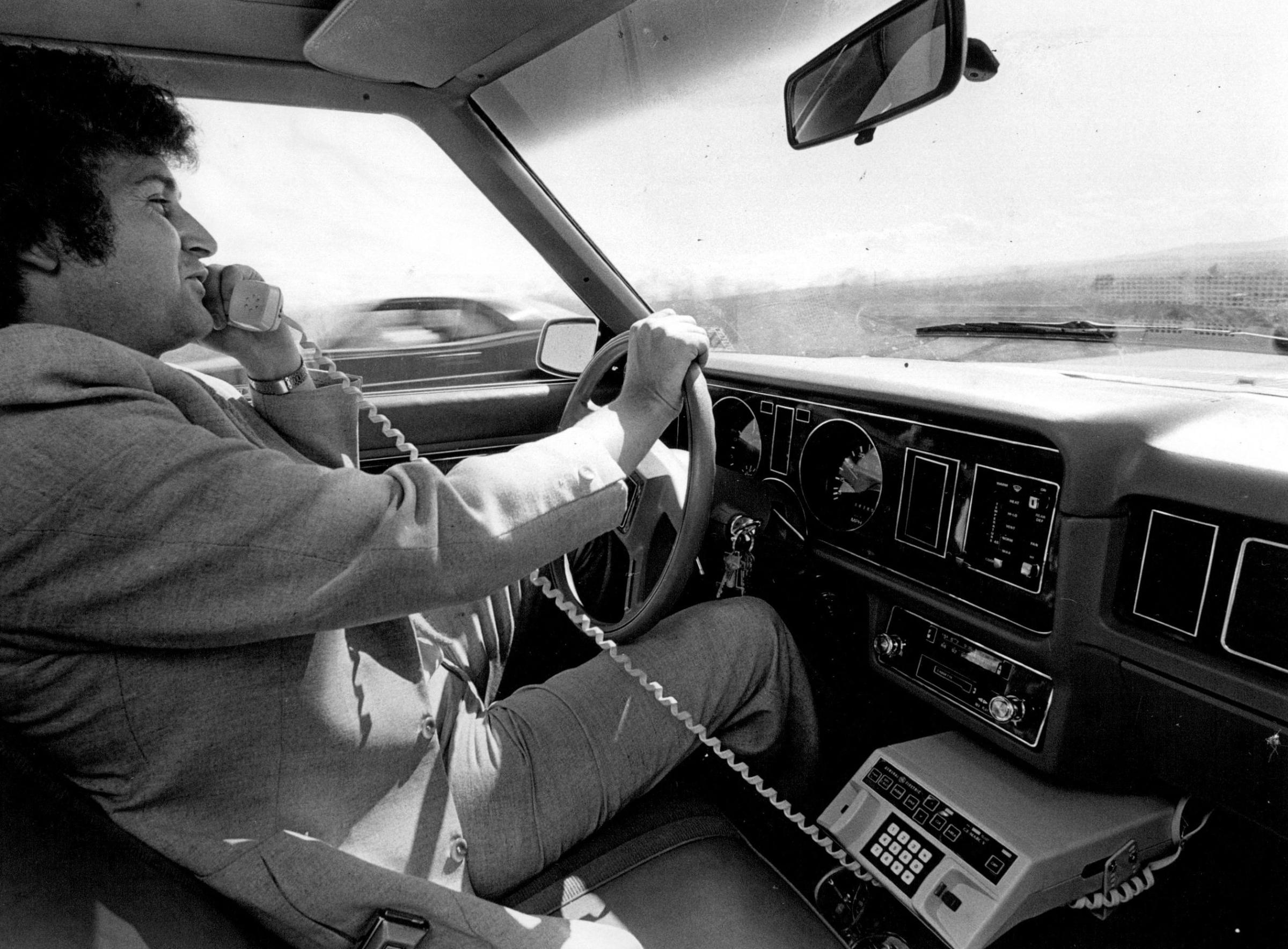 Bob Maxwell, general manager of Englewood-based Mobile Telephone of Colorado, places a call on FCC-approved radio frequency while driving to work.