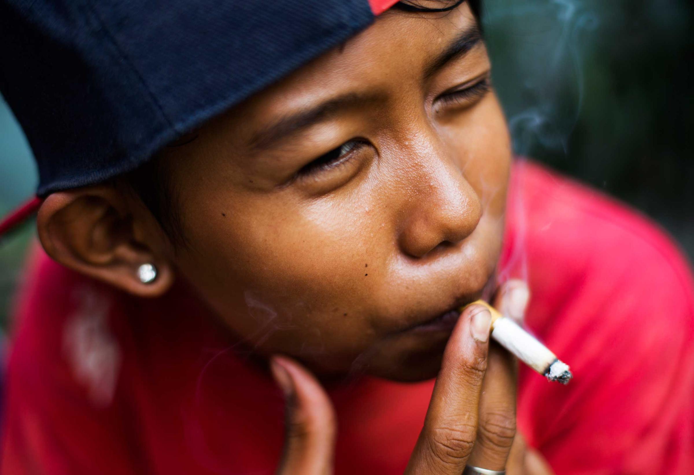 Ompong, which means "toothless" in Bahasa, poses for a photograph as he has a cigarette in South Jakarta, Indonesia on February 14, 2014.