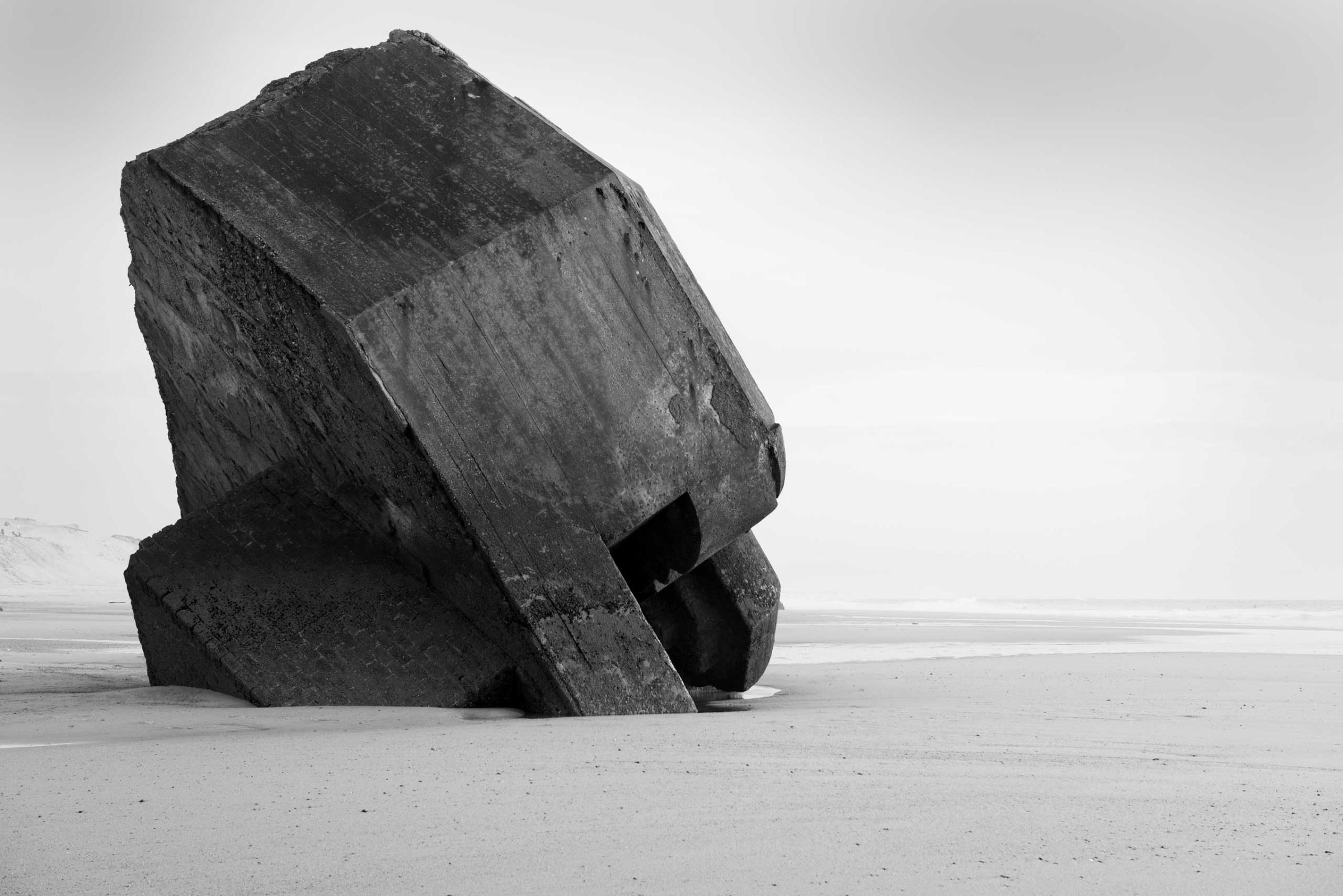 The remnants of a concrete defensive structure used by the German Army during World War II juts out of the sand along a beach in nothern France along the route of the Atlantic Wall (Atlantikwall in German).