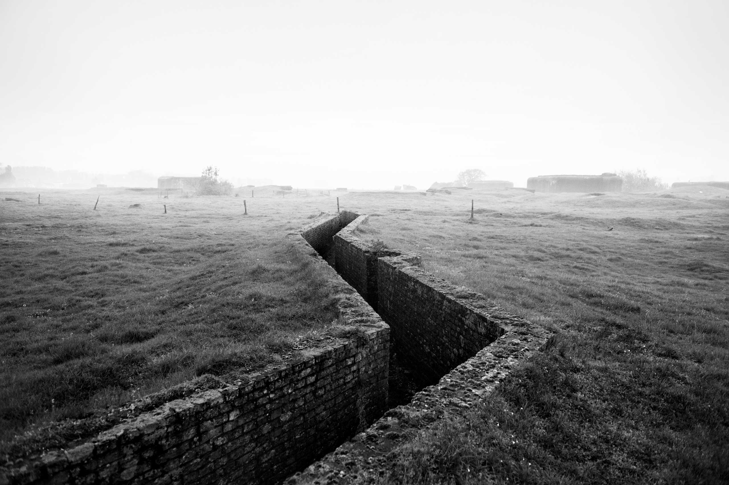 A brick trench runs through a field along the route of the Atlantic Wall (Atlantikwall in German).