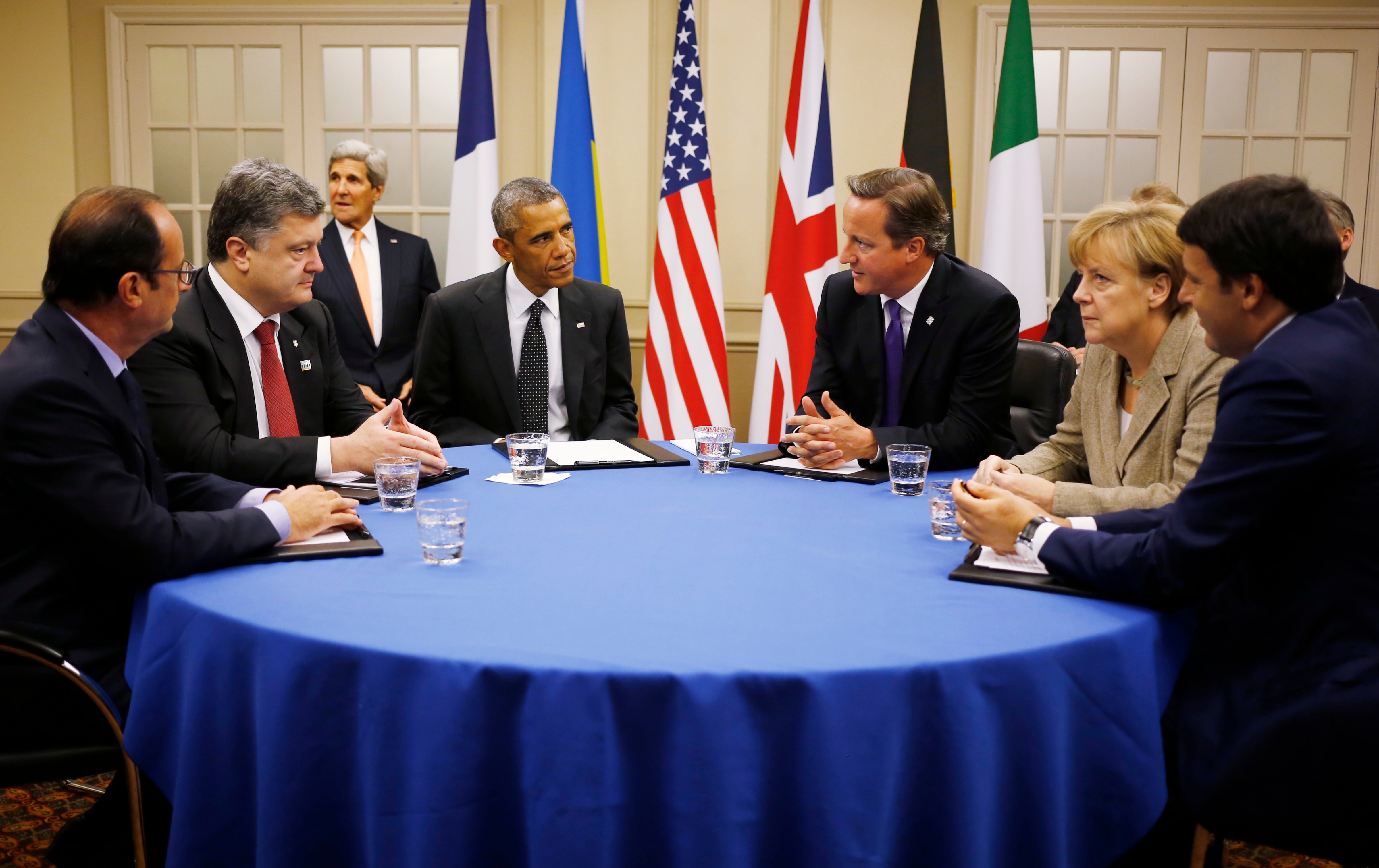 President Barack Obama is seated at a table with, from left to right: France's President Francois Hollande; Ukraine President Petro Poroshenko; British Prime Minister David Cameron; German Chancellor Angela Merkel; and Italian Prime Minister Matteo Renzi as they meet about Ukraine at the NATO summit at Celtic Manor in Newport, Wales on Sept. 4, 2014. (Charles Dharapak—AP)
