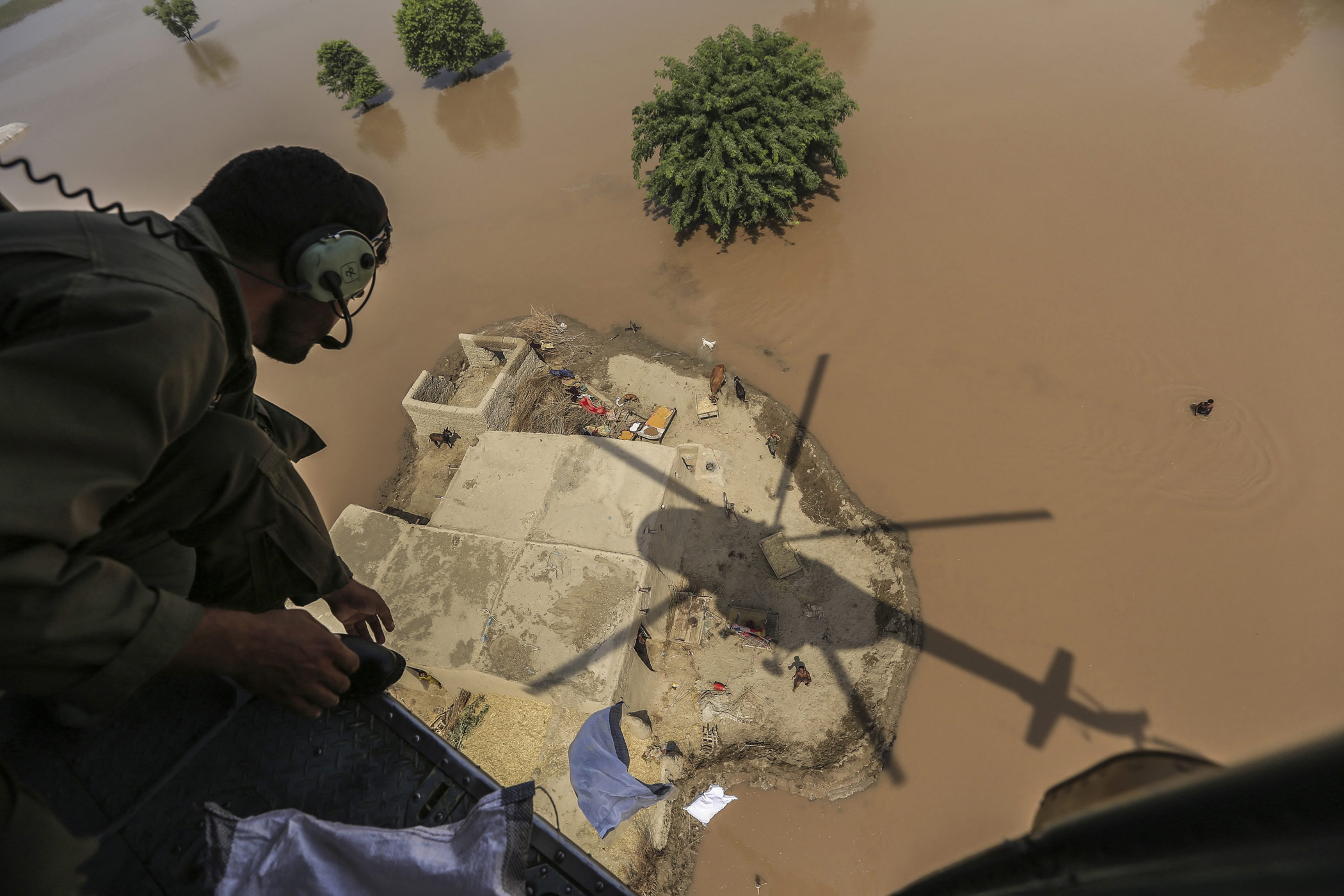 A Pakistani Army soldier distributes food bags in flooded areas in Shujabad, on the outskirts of Multan, Pakistan, Sept. 15, 2014.