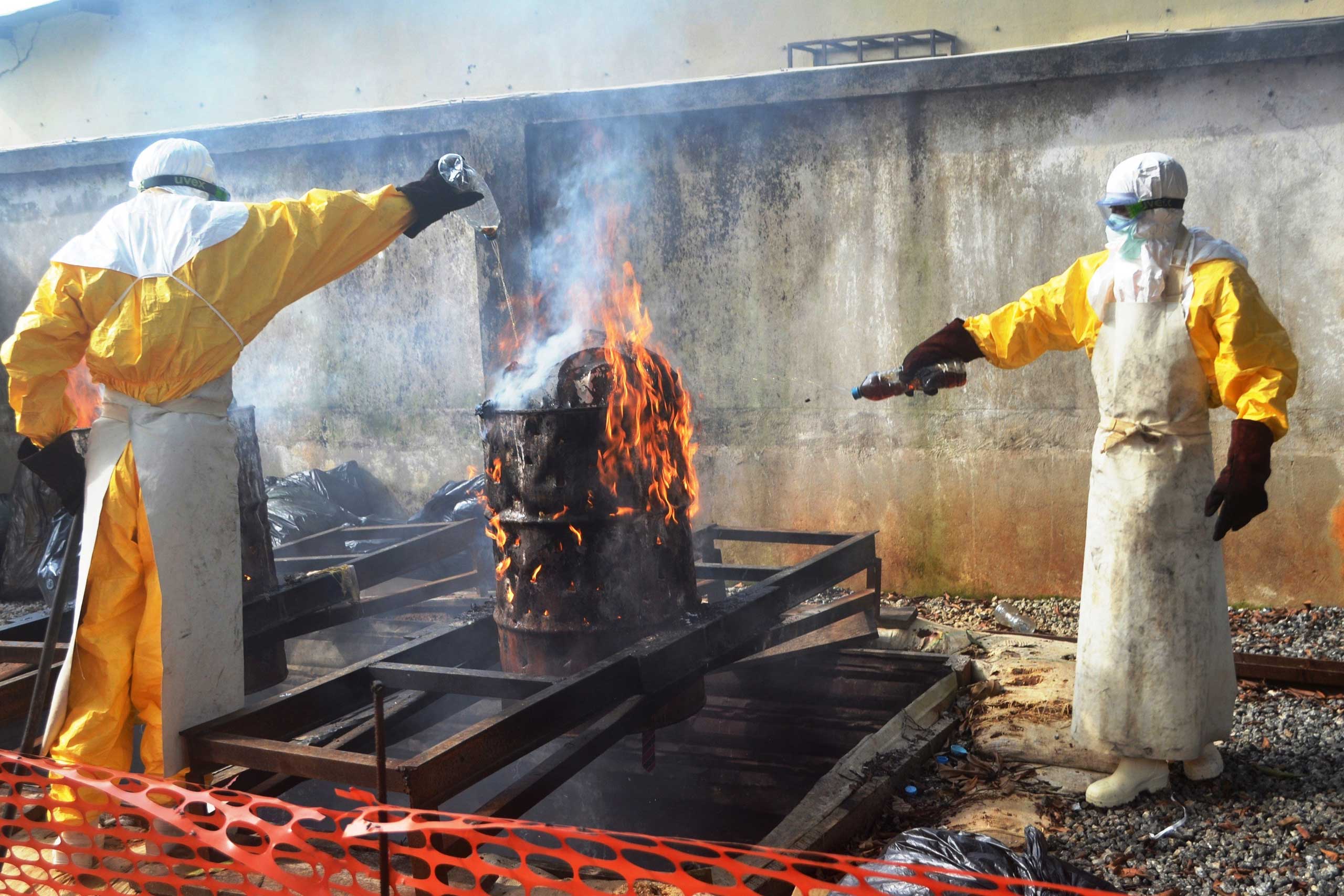Sept. 13, 2014. Health workers burn used protection gear at a Medecins Sans Frontieres center in Conakry, Guinea.