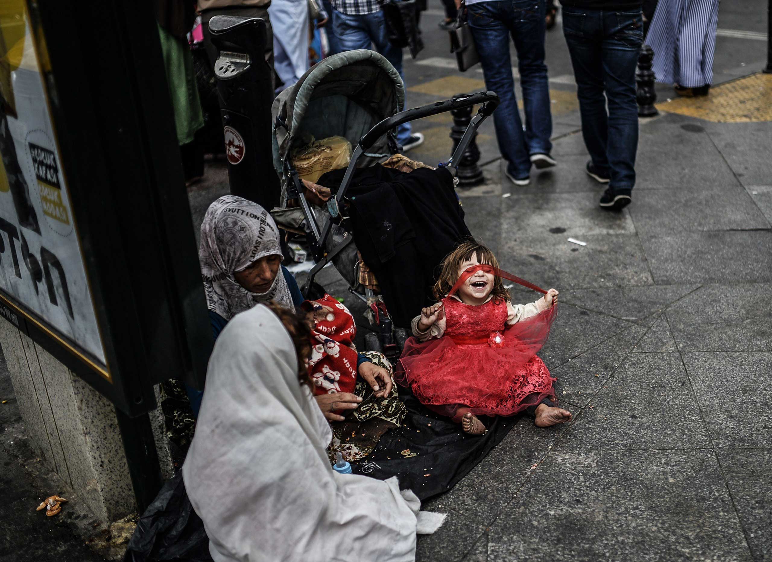 Sept. 17, 2014. A Syrian woman with her four children begs on the street in Istanbul.