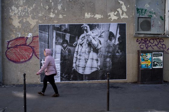 A woman walks in front of one of Zacharie Scheurer's photographs shot in Lebanon.