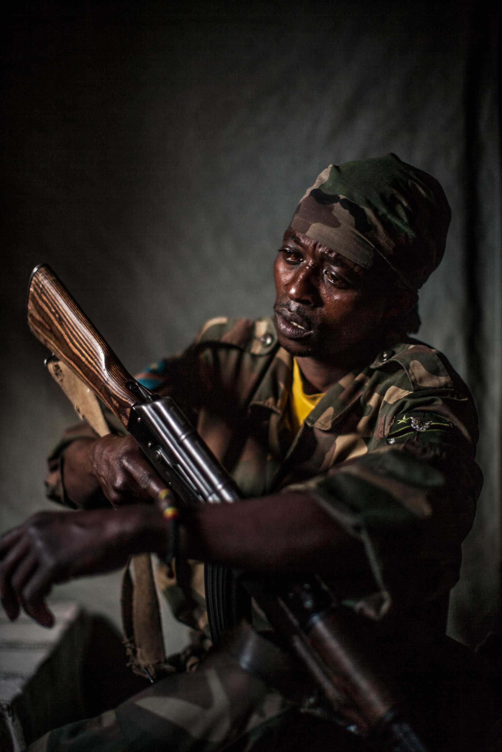 An unnamed Congolese soldier sits for a portrait in a village in North Kivu province.