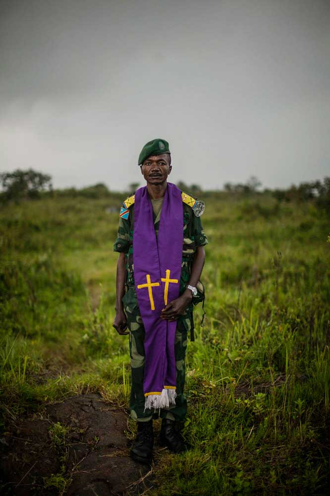 A Congolese military chaplain stands near the frontline with M23 rebels outside Goma.