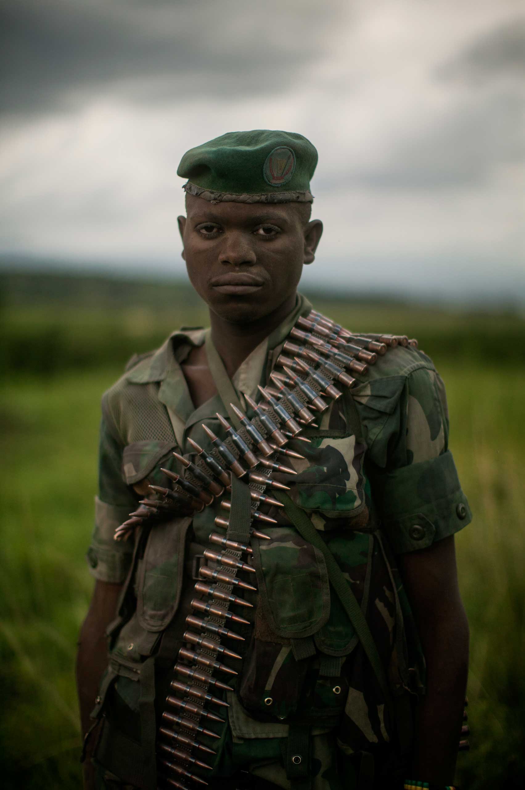 An unnamed Congolese soldier stands for a portrait in a village in North Kivu province.