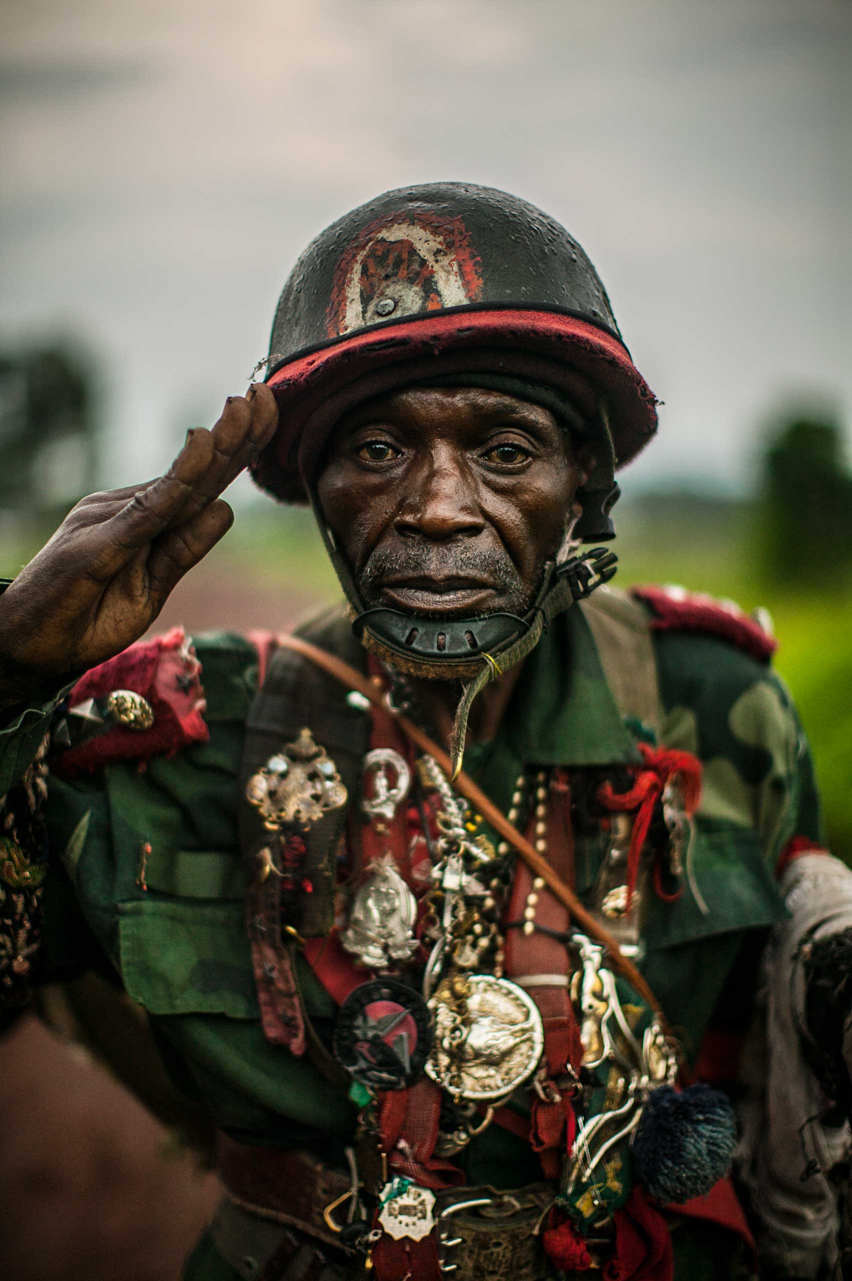 An unnamed Congolese soldier stands for a portrait in a village in North Kivu province.