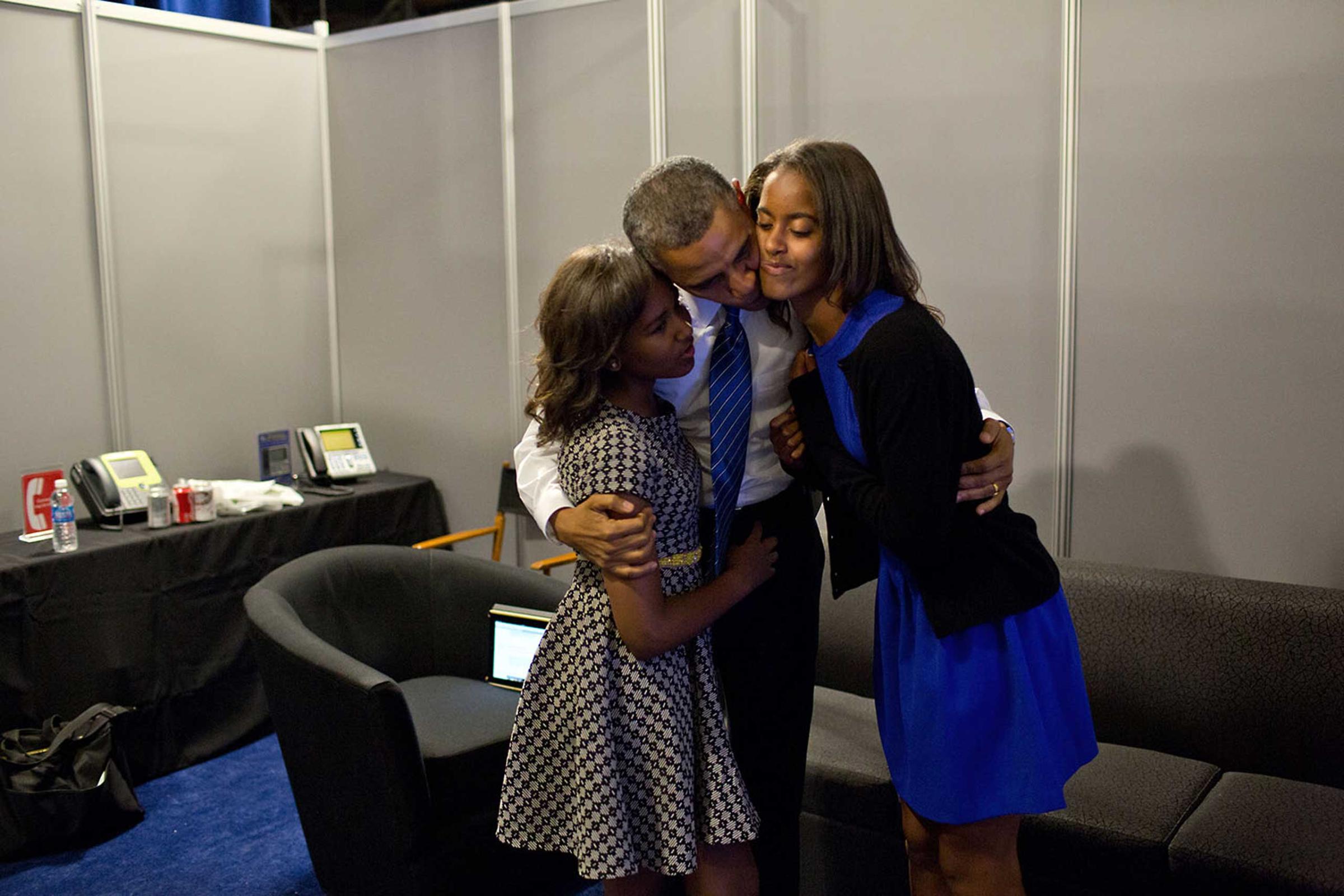 President Obama greets daughters Sasha and Malia at the Time Warner Cable Arena before delivering remarks at the Democratic National Convention in Charlotte, N.C., Sept. 6, 2012.