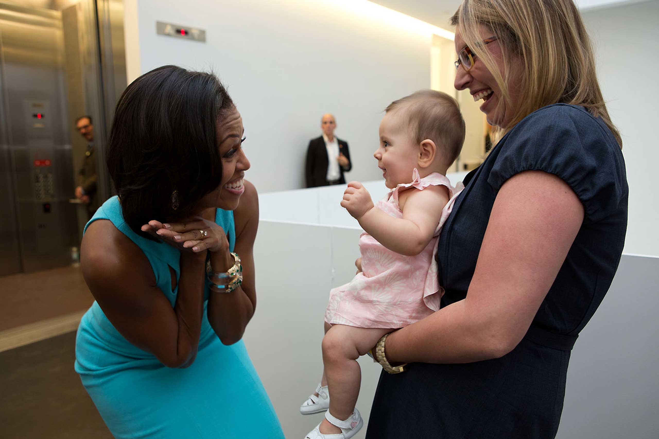 First Lady Michelle Obama greets former White House staffer Franny Starkey and her daughter Willa prior to an event at the Museum of Contemporary Art Denver in Denver, Colo., Aug. 11, 2012.