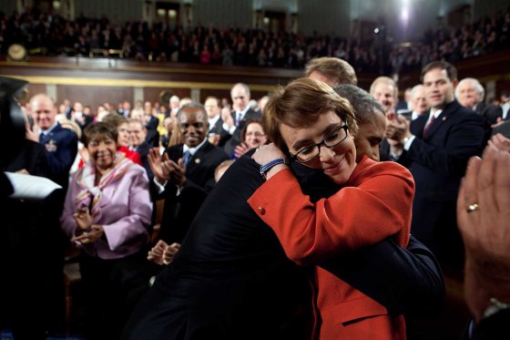 President Barack Obama greets then Rep. Gabrielle Giffords, D-Ariz., as he arrives to deliver the State of the Union address in the House Chamber at the U.S. Capitol in Washington, D.C., Jan. 24, 2012.