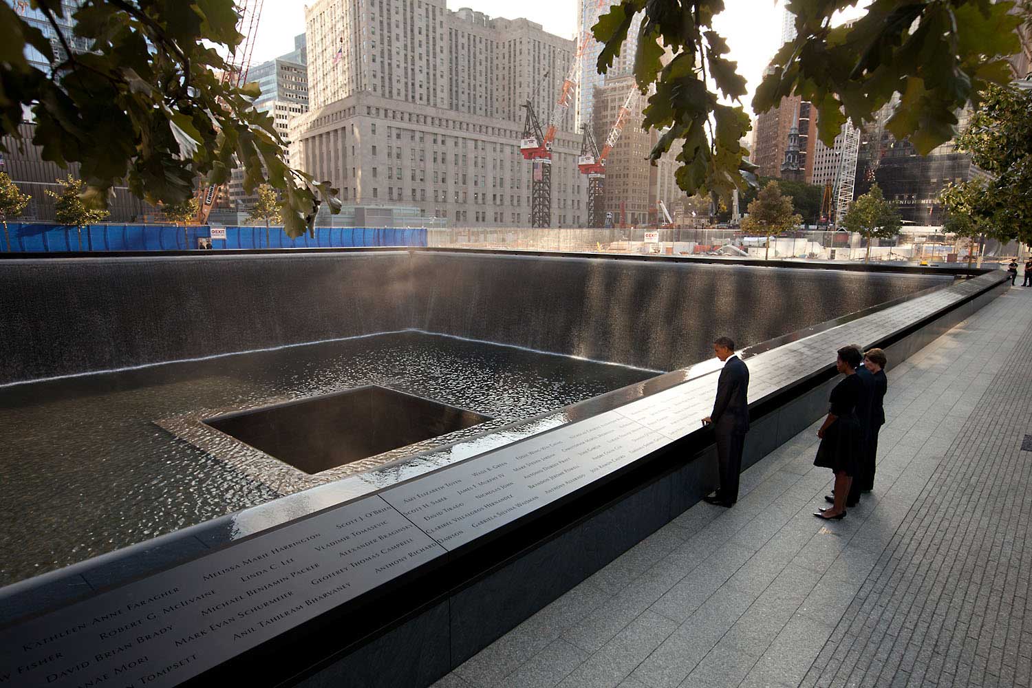 "Chuck Kennedy captured this scene with a remote camera as the President and First Lady, along with former President George W. Bush and former First Lady Laura Bush, paused at the North Memorial Pool of the National September 11 Memorial in New York City. The North Memorial pool sits in the footprint of the north tower, formerly 1 World Trade Center."