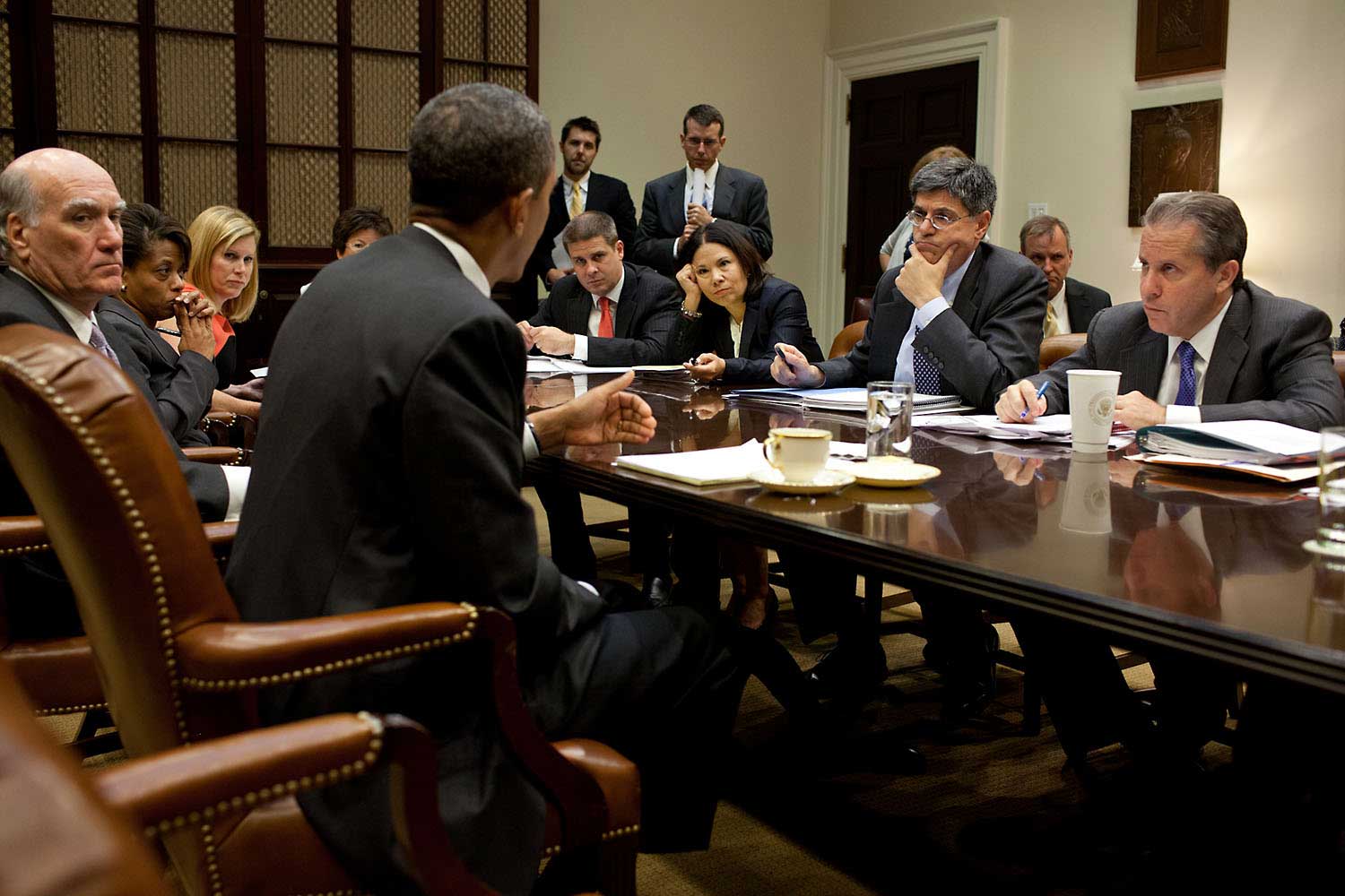 White House aides listen as President Obama makes a point during a meeting in the Roosevelt Room of the White House, Sept. 7, 2011.