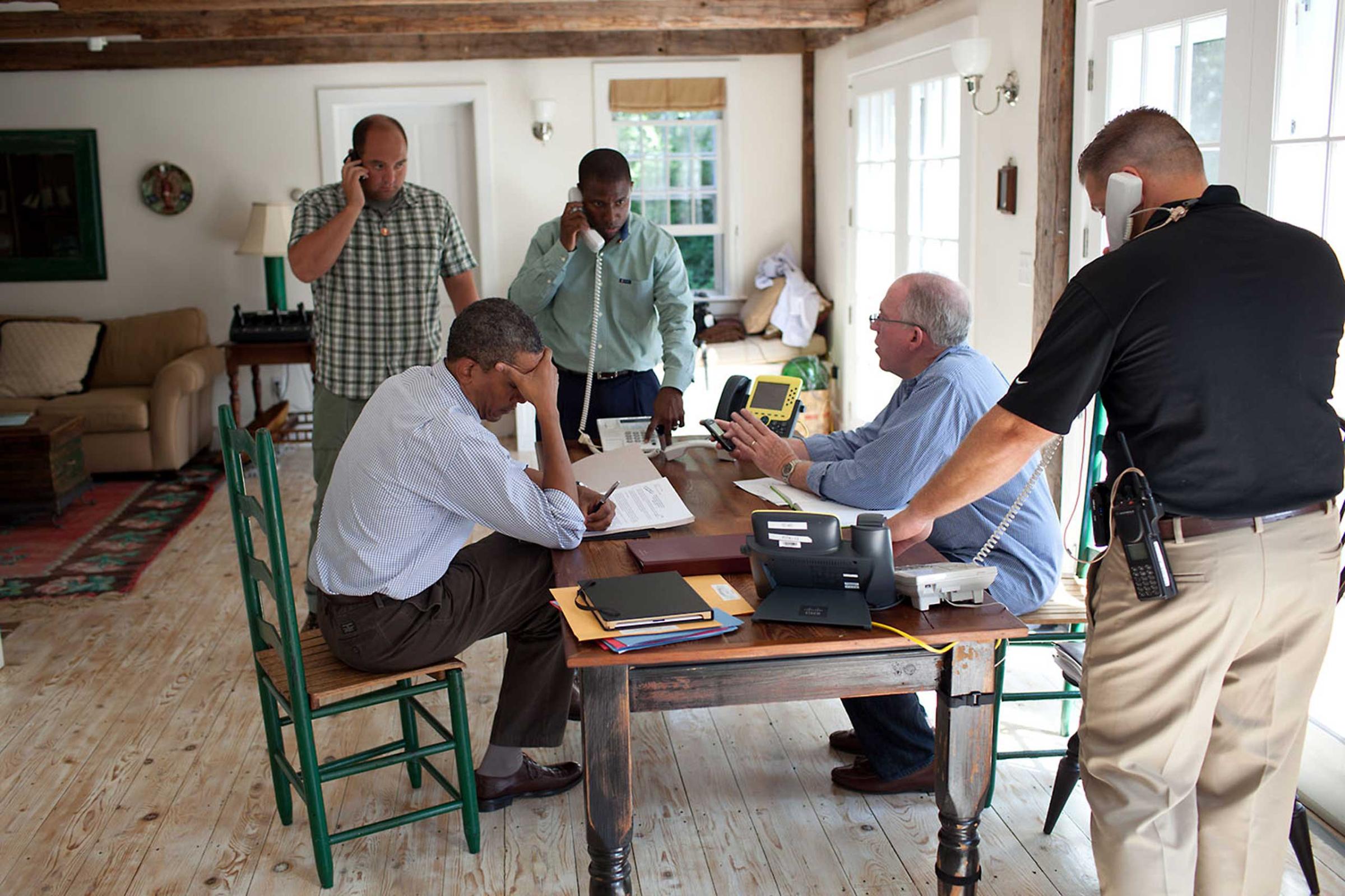 "A former President once said, 'Presidents don't get vacations, they just get a change of scenery.' We were on 'vacation' in Martha's Vineyard and the President was monitoring Hurricane Irene with John Brennan, Assistant to the President for Homeland Security and Counterterrorism, at right in light blue shirt, on Aug. 26, 2011. They were waiting for a conference call on the hurricane with affected governors and mayors."