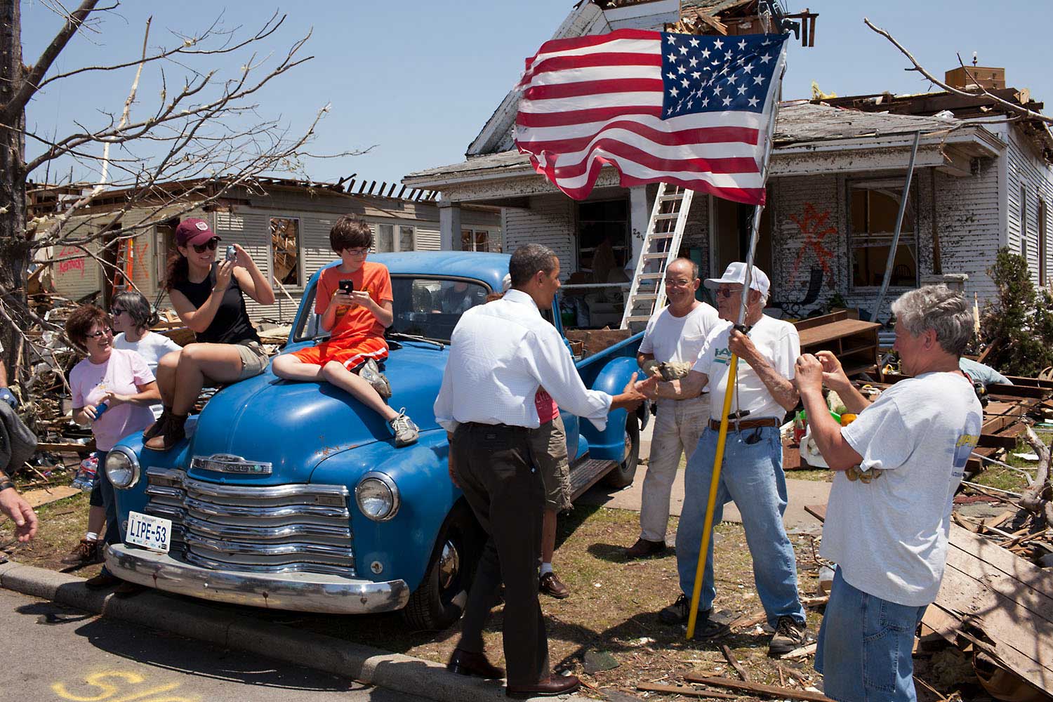 The President visits Joplin, Mo., on May 29, 2011, following a devastating tornado. Here he greets Hugh Hills, 85, in front of his home. Hills told the President he hid in a closet during the tornado, which destroyed the second floor and half the first floor of his house.