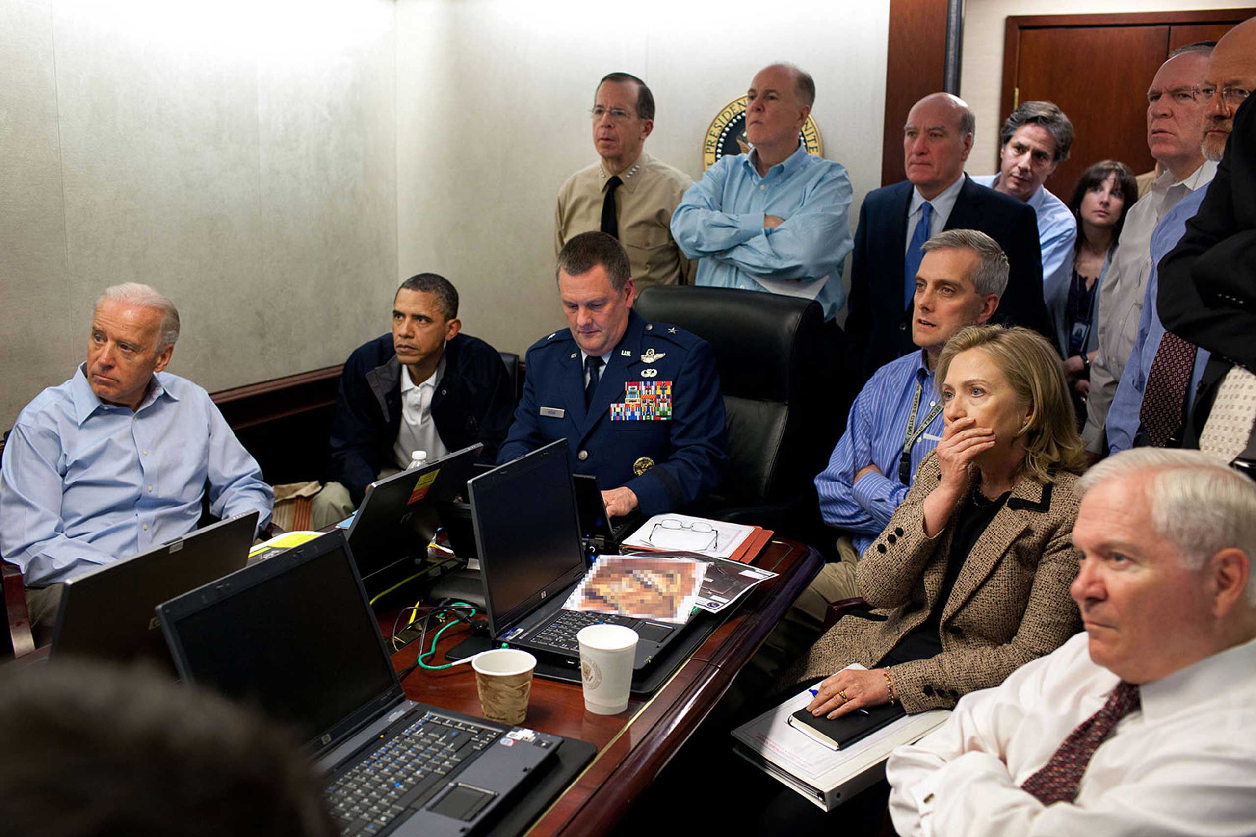 Much has been made of this photograph that shows the President and Vice President and the national security team monitoring in real time the mission against Osama bin Laden, May 1, 2011. Some more background on the photograph: The White House Situation Room is actually comprised of several different conference rooms. The majority of the time, the President convenes meetings in the large conference room with assigned seats. But to monitor this mission, the group moved into the much smaller conference room. The President chose to sit next to Brigadier General Marshall B.  Brad  Webb, Assistant Commanding General of Joint Special Operations Command, who was point man for the communications taking place. With so few chairs, others just stood at the back of the room. I was jammed into a corner of the room with no room to move. During the mission itself, I made approximately 100 photographs, almost all from this cramped spot in the corner. Please note: a classified document seen in front of Sec. Clinton has been obscured.