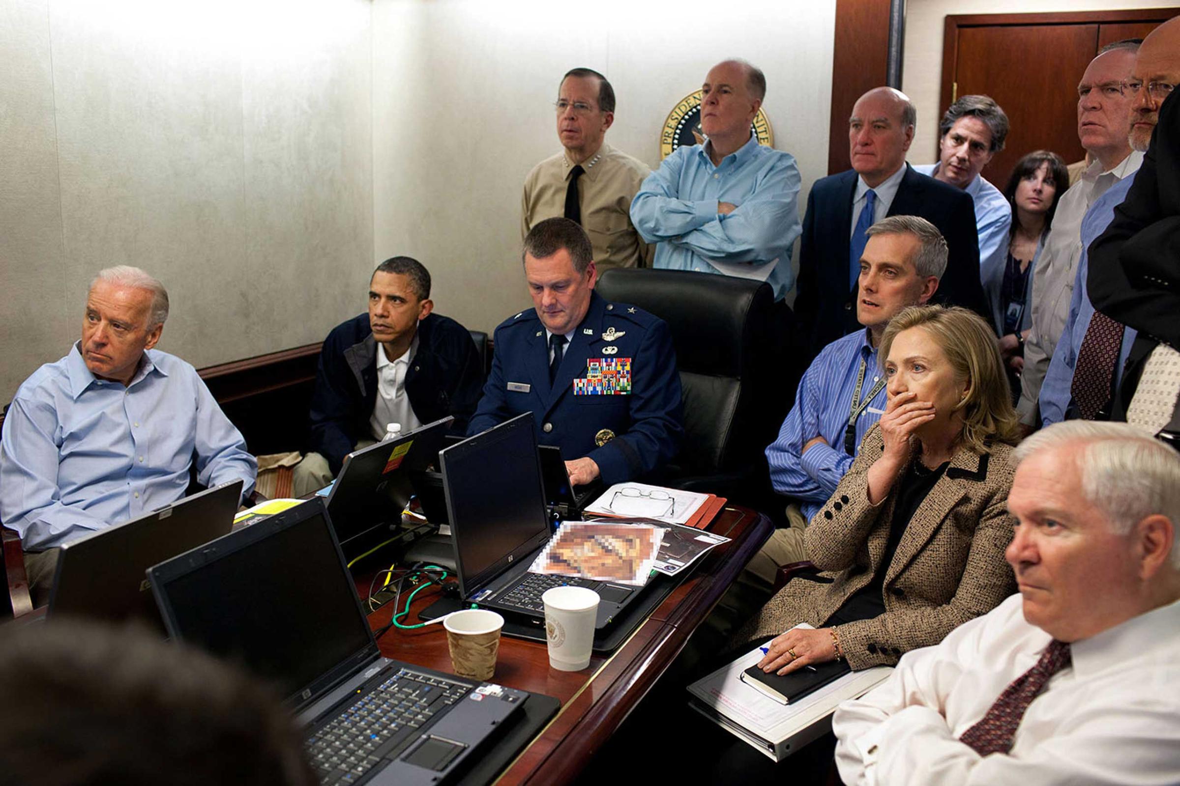 "Much has been made of this photograph that shows the President and Vice President and the national security team monitoring in real time the mission against Osama bin Laden, May 1, 2011. Some more background on the photograph: The White House Situation Room is actually comprised of several different conference rooms. The majority of the time, the President convenes meetings in the large conference room with assigned seats. But to monitor this mission, the group moved into the much smaller conference room. The President chose to sit next to Brigadier General Marshall B. ÒBradÓ Webb, Assistant Commanding General of Joint Special Operations Command, who was point man for the communications taking place. With so few chairs, others just stood at the back of the room. I was jammed into a corner of the room with no room to move. During the mission itself, I made approximately 100 photographs, almost all from this cramped spot in the corner. Please note: a classified document seen in front of Sec. Clinton has been obscured."