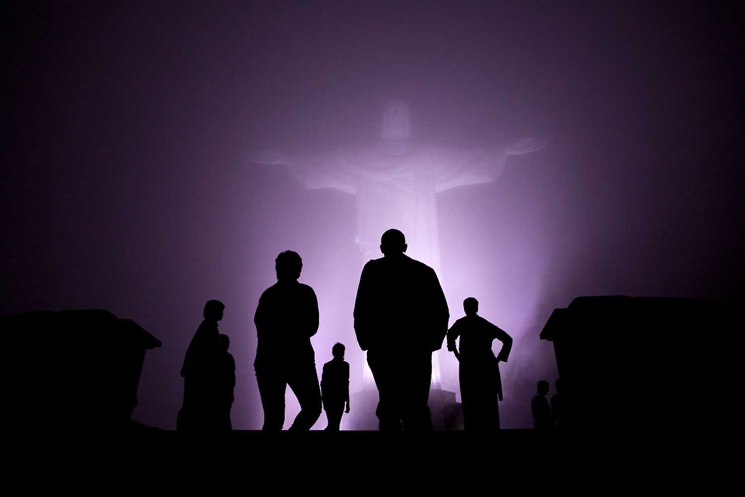 "The Obama family was scheduled to tour the Christ the Redeemer statue in Rio de Janeiro, Brazil, before dinner one night March 20, 2011. But when heavy fog rolled in, they decided to cancel the visit. After dinner though, the fog had dissipated somewhat so they decided to make the drive up the mountain after all. It was quite clear when they arrived and then the fog started to roll back in. I managed to capture this silhouette as they viewed the statute one last time just before departure."
