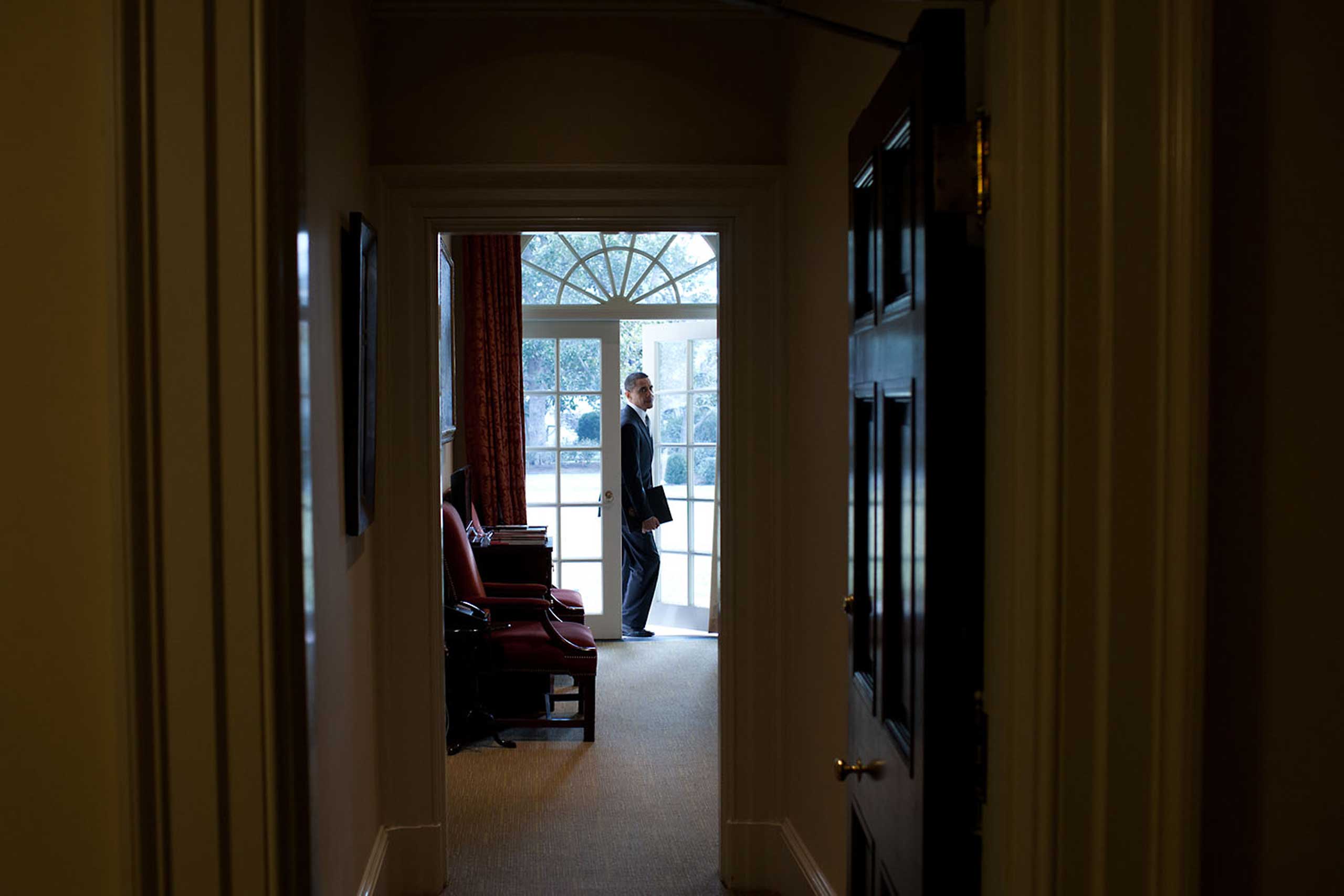 President Obama walks through the door of the Outer Oval Office at the start of the day, Feb. 24, 2011. This is his usual point of entry to the Oval Office each morning.