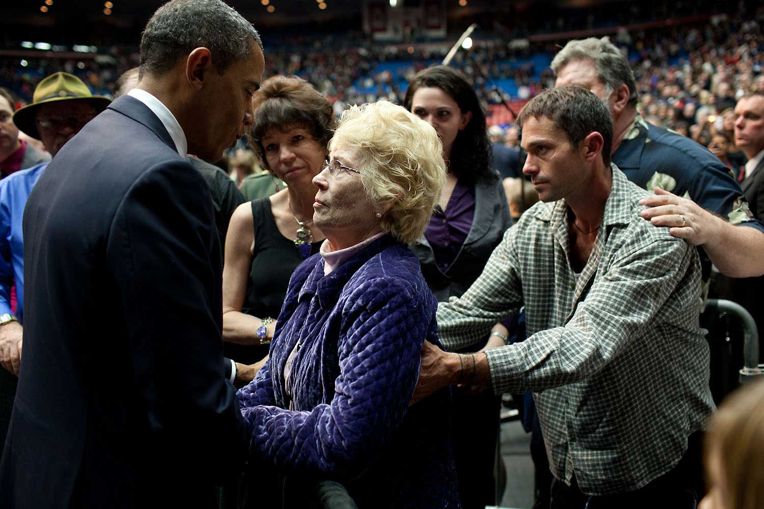 "A terrible tragedy occurred on a Saturday in January when a gunman shot Rep. Gabrielle Giffords and 18 others in Tucson, Ariz. A few days later, on Jan. 12, 2011, the President spoke at a memorial service for the six victims who died and those wounded. Here he greets Mavy Stoddard, whose husband Dorwan died while protecting her during the shooting."