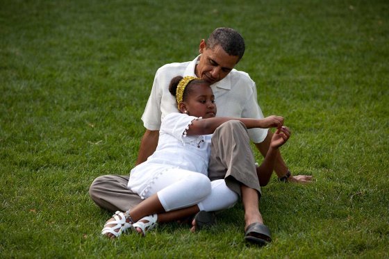 President Obama shares a moment with his daughter Sasha during a barbecue in celebration of his 49th birthday on the South Lawn of the White House, Aug. 8, 2010.