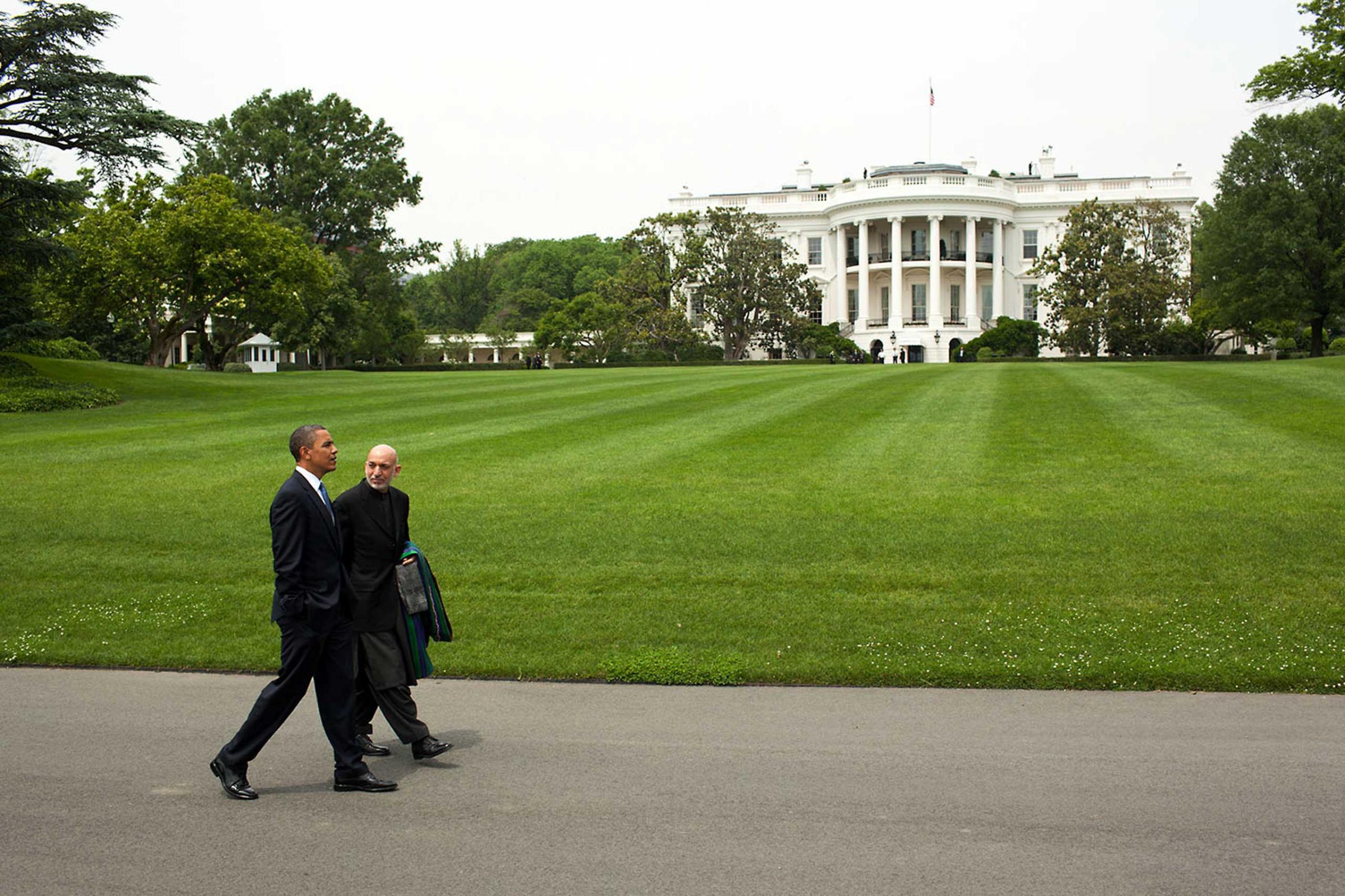 President Obama and President Hamid Karzai of Afghanistan walk along the South Lawn Drive of the White House, following their working lunch, May 12, 2010.