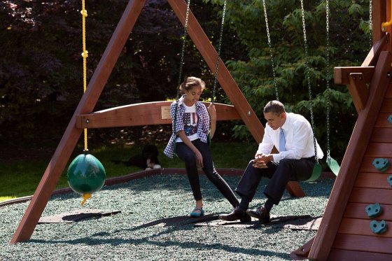President Obama talks with his daughter Malia on the swing set outside the Oval Office, May 4, 2010.