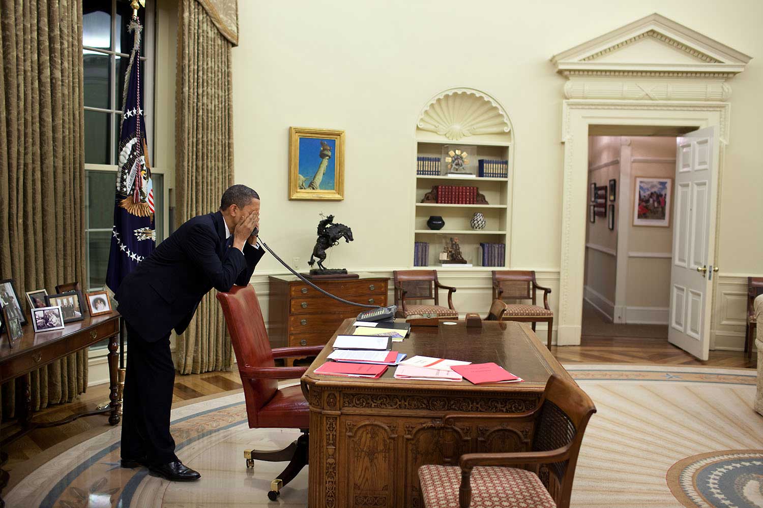 After dinner with his family on March 19, 2009, the President works the phone in the Oval Office to continue pressing Congressmen to vote for the health care reform bill.