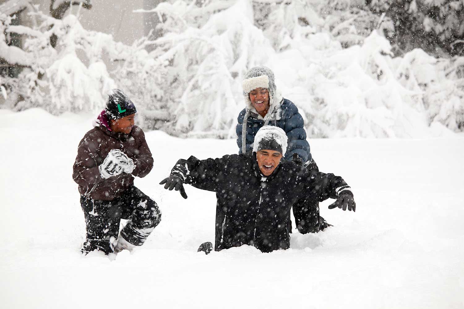 President Barack Obama and his daughters, Sasha and Malia, play in the snowstorm at the White House, Saturday, Feb. 6, 2010.