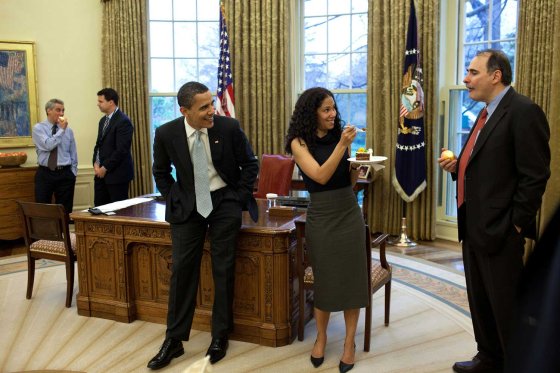 Deputy chief of staff Mona Sutphen jokingly offers a piece of birthday cake to senior advisor David Axelrod as the President watches amusingly in the Oval Office, April 15, 2009. The party was held to commemorate senior advisor Pete Rouse's birthday.