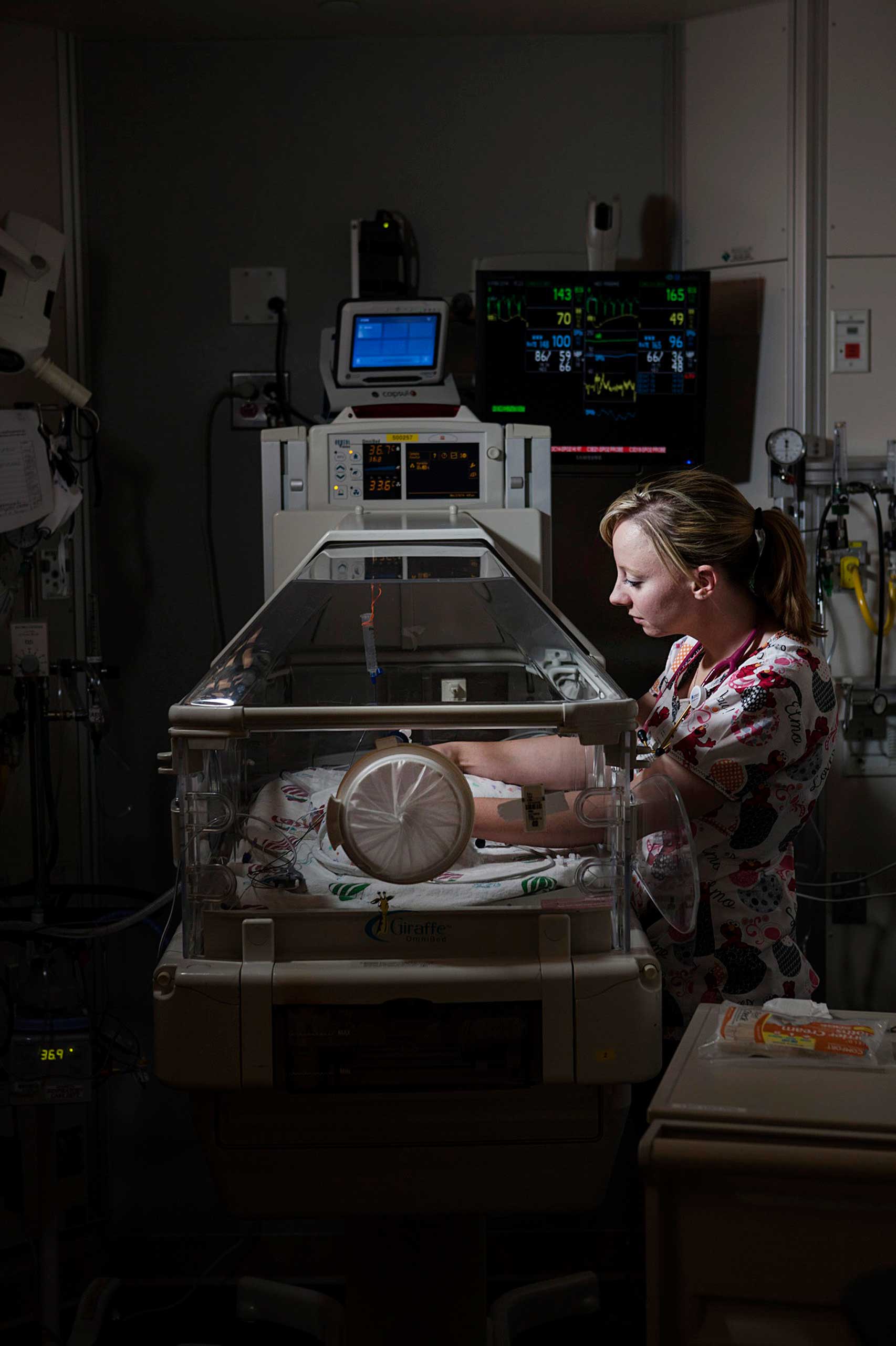 A nurse tends to David as he lies in an incubator at the ChildrenÕs Hospital of Wisconsin.