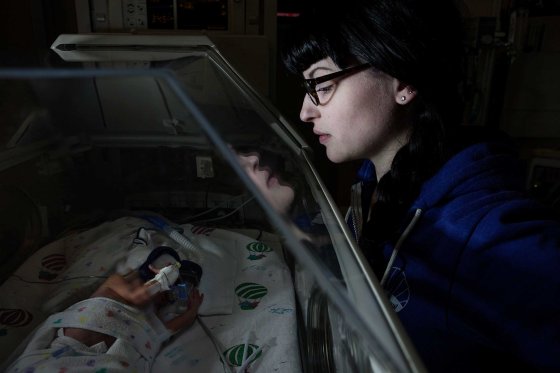 Melissa, David's mother, looks in at him as he lies in an incubator at the Children’s Hospital of Wisconsin.