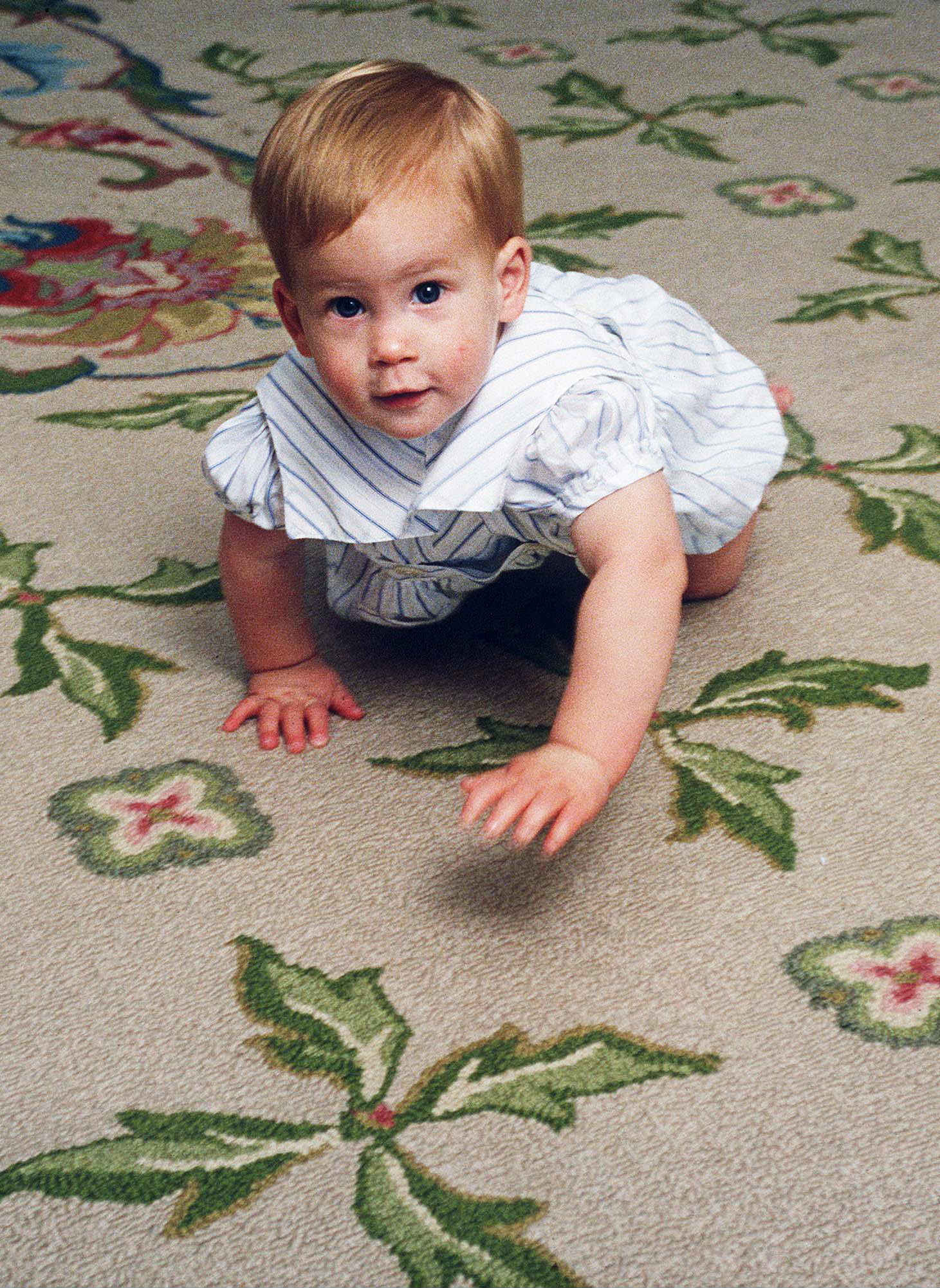 Prince Harry learning to crawl at home in Kensington Palace, London on Oct. 4, 1985.
