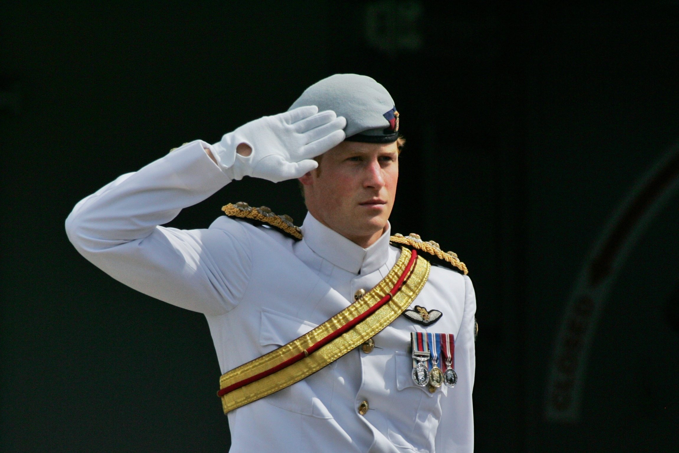 Prince Harry salutes the ceremonial guards at Garden Island Naval Base for the International Fleet Review in Sydney on Oct. 5, 2013.