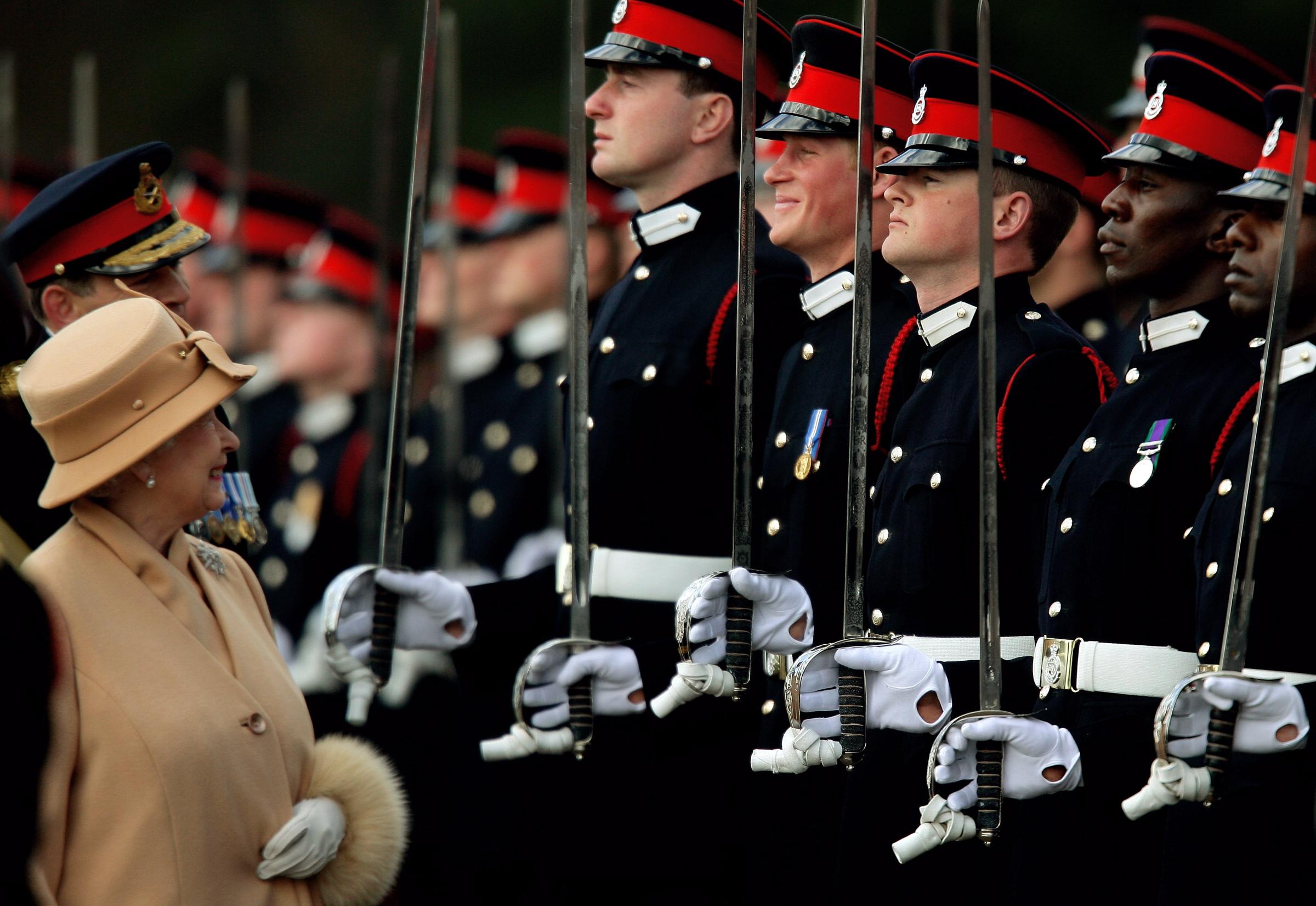 Britains Queen Elizabeth smiles with Prince Harry during Sovereigns Parade at Royal Military Academy in Sandhurst