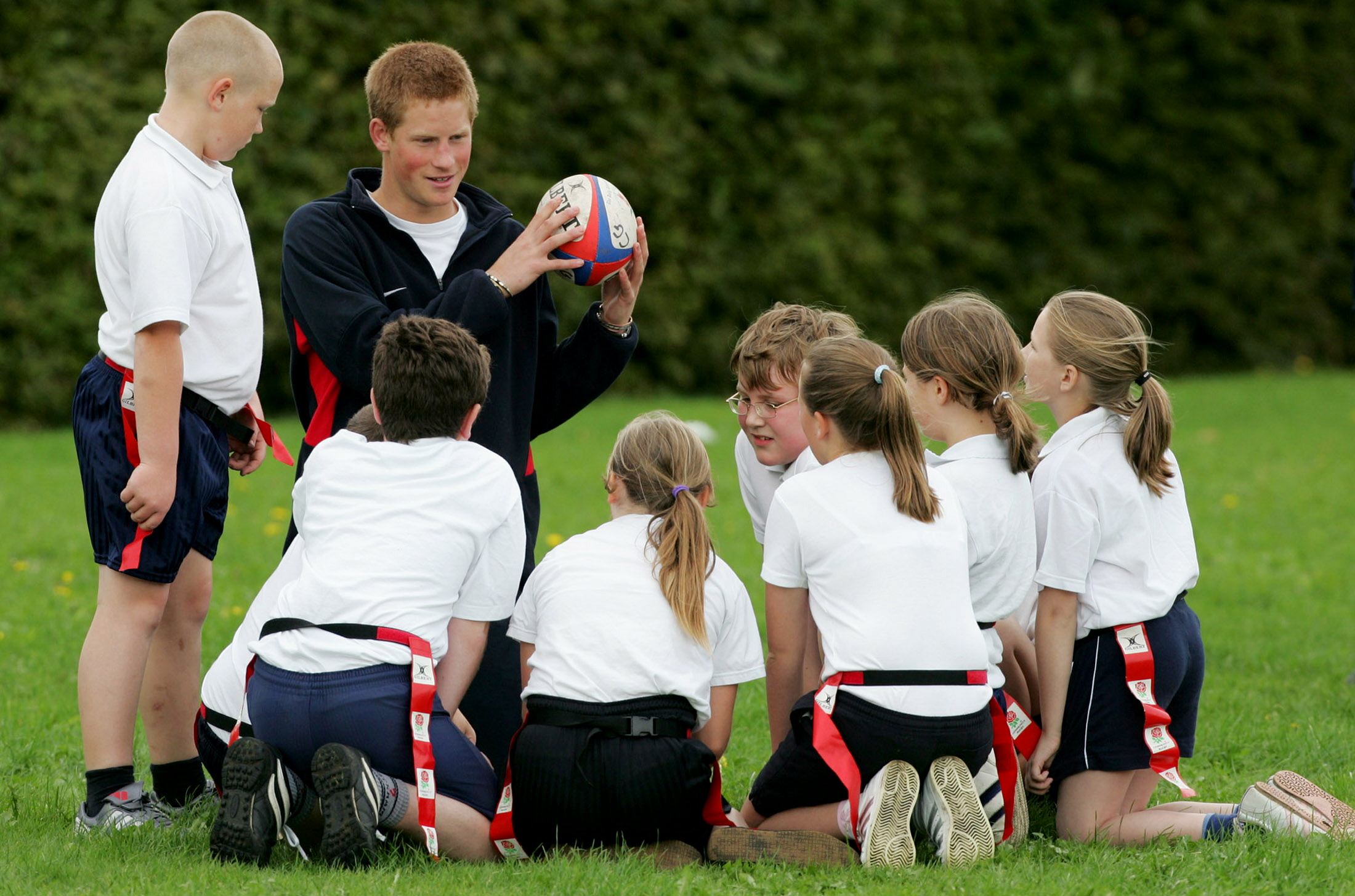 Britain's Prince Harry teaches rugby as a voluntary coach for the RFU at a school in central England