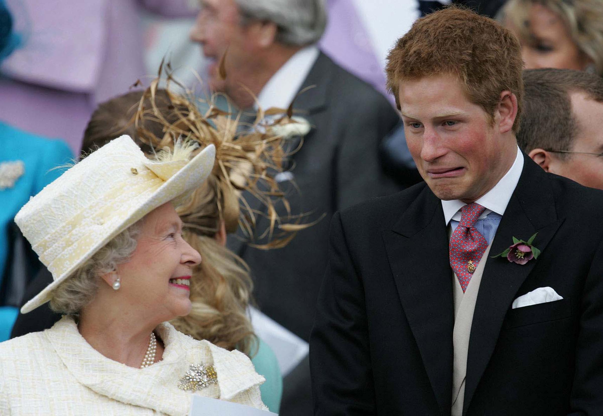 Britain's Queen Elizaberth II smiles as Prince Harry pulls a face as they watch Prince Charles and the ...