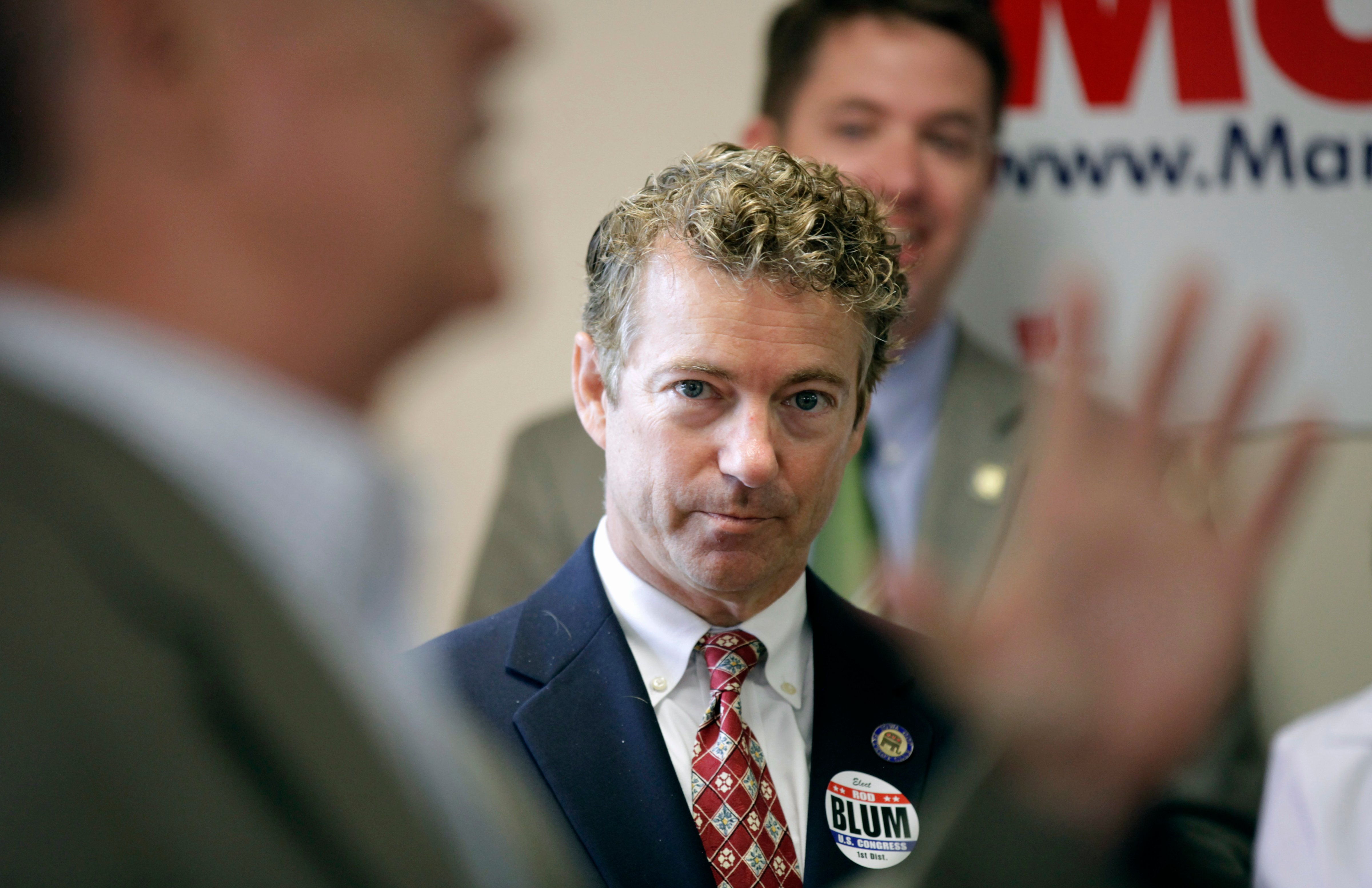 Sen. Rand Paul, R-Ky. listens he is introduced to speak by Iowa Republican congressional candidate Rod Blum, left, during a meeting with local Republicans, Aug. 5, 2014, in Hiawatha, Iowa. (Charlie Neibergall—AP)
