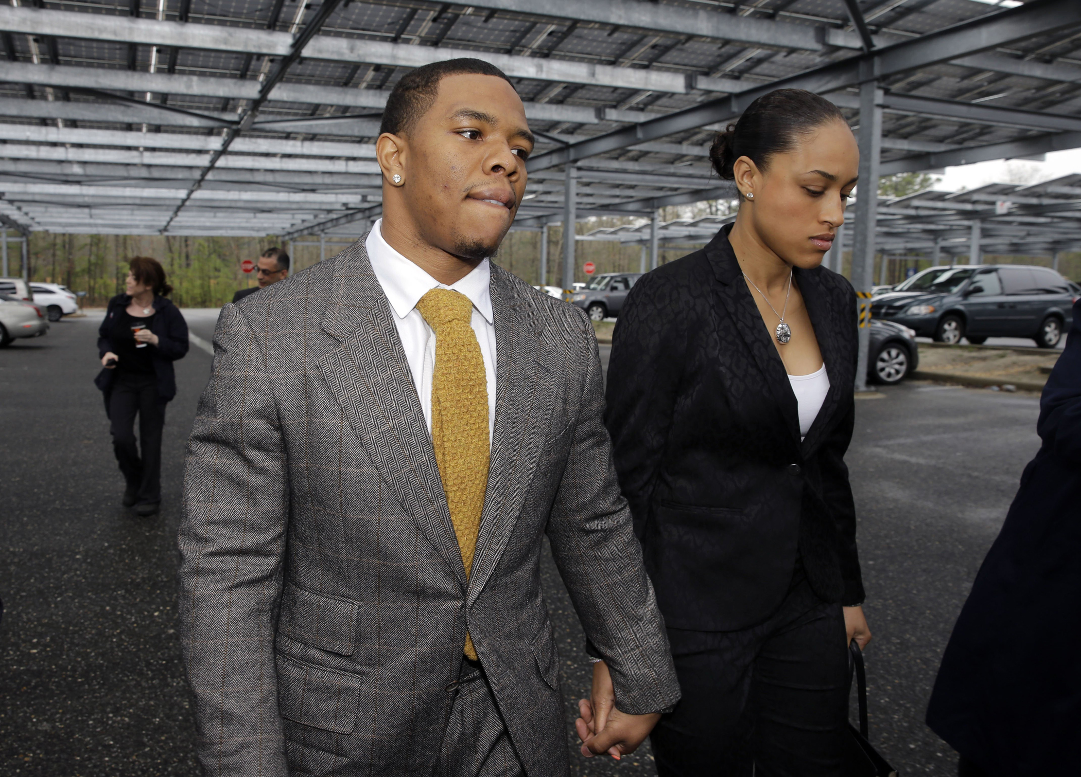 Baltimore Ravens football player Ray Rice holds hands with his wife, Janay Palmer, as they arrive at Atlantic County Criminal Courthouse in Mays Landing, N.J., in May 2014.