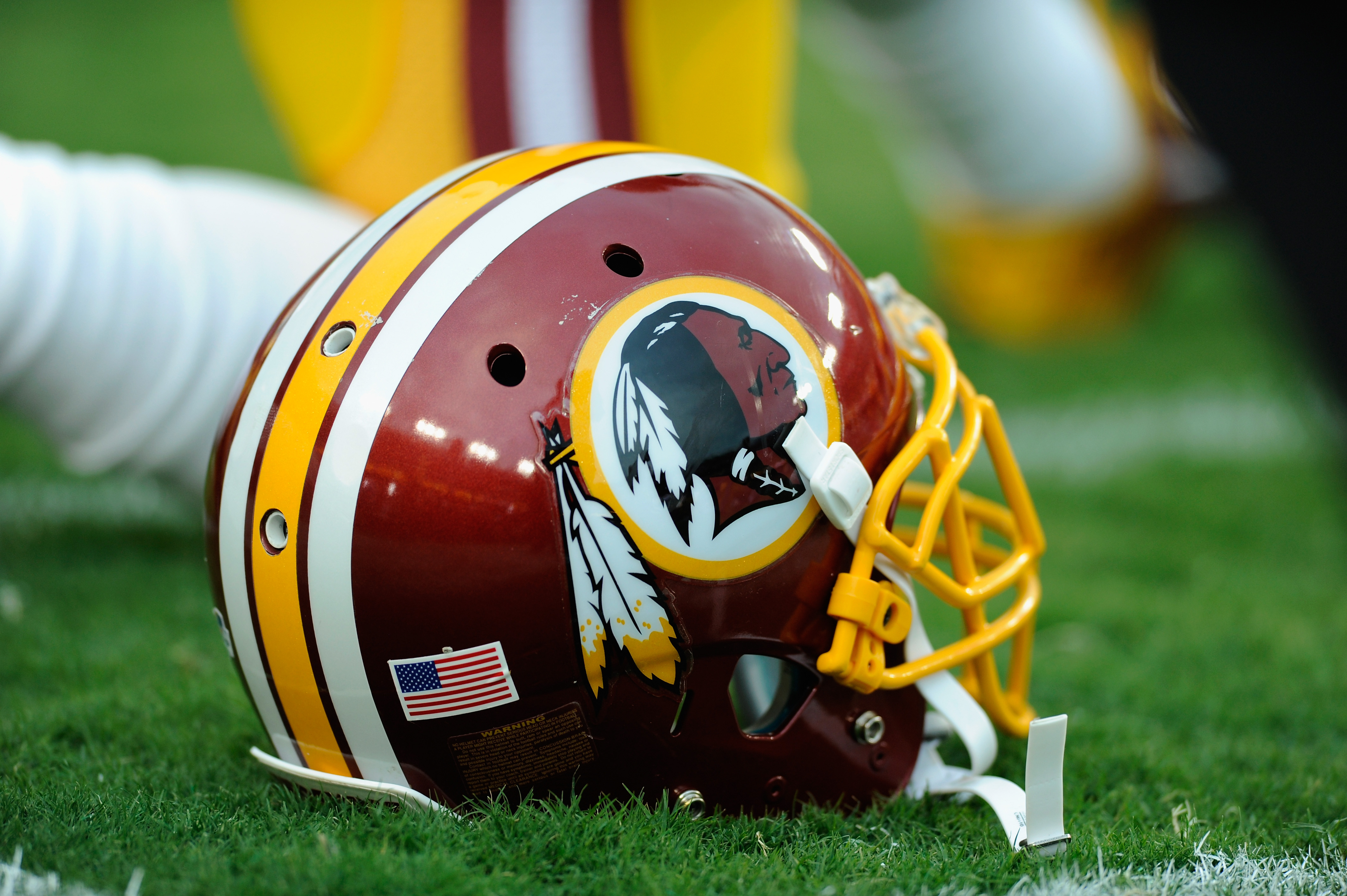 A Washington Redskins helmet sits on the grass during a preseason football game between the Redskins and Cleveland Browns at FedExField on August 18, 2014 in Landover, Maryland. (TJ Root—Getty Images)