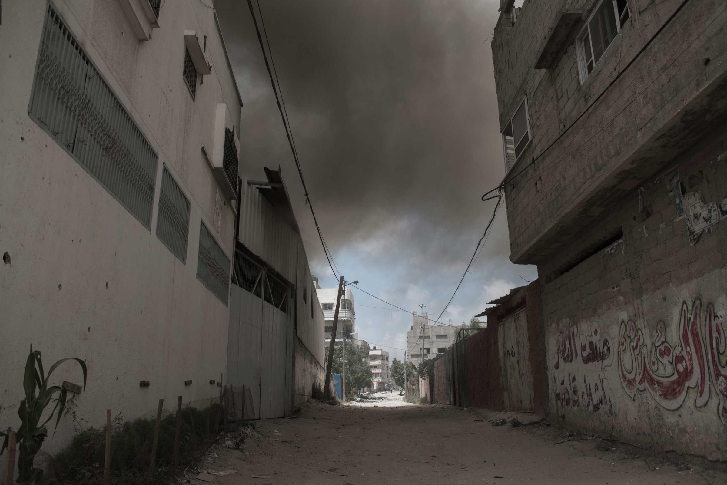 Following a heavy Israeli attack by shelling and airstrikes, smoke is seen in the Shejaiya district of Gaza City during a humanitarian cease-fire, July 20, 2014.