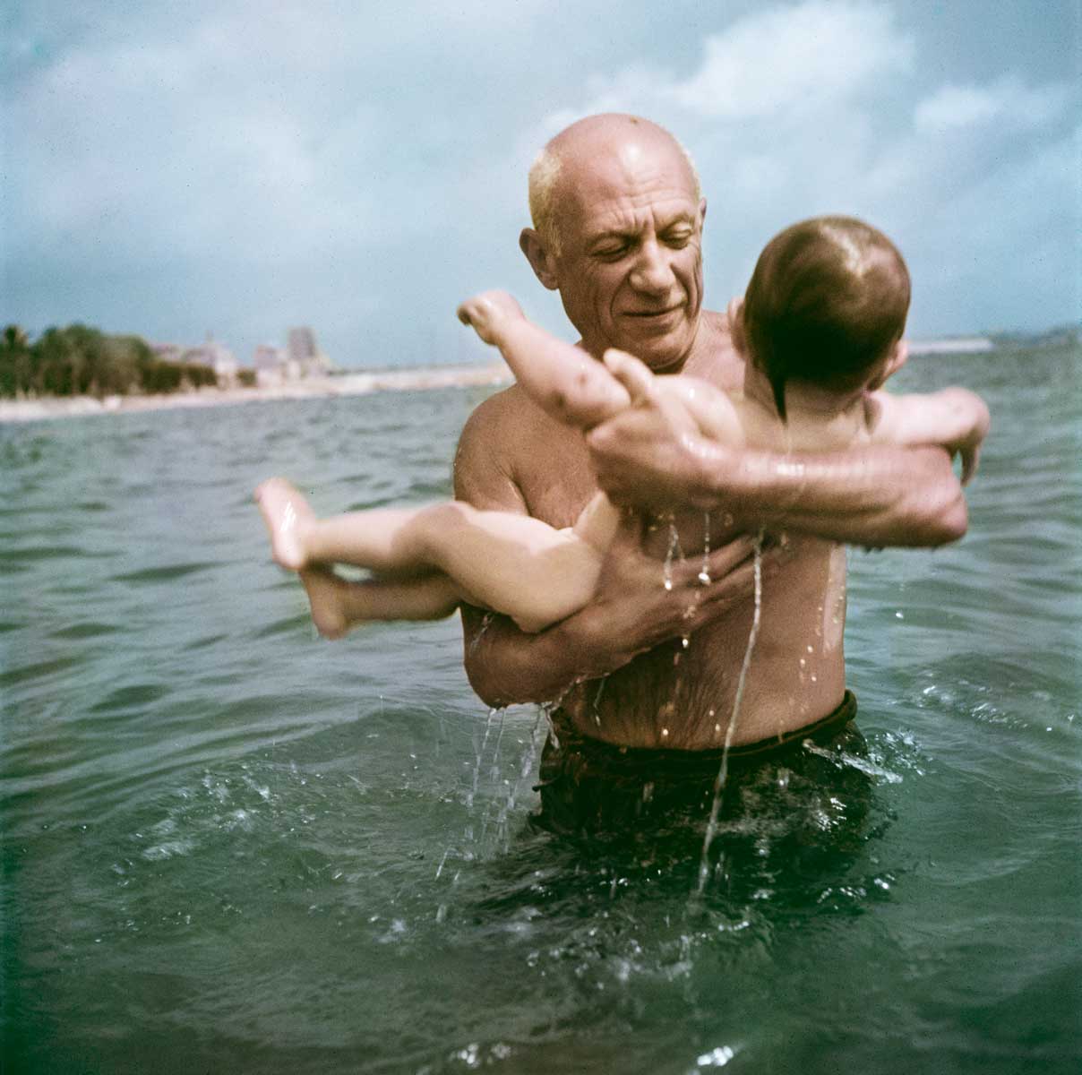 Pablo Picasso playing in the water with his son Claude, Vallauris, France, 1948.