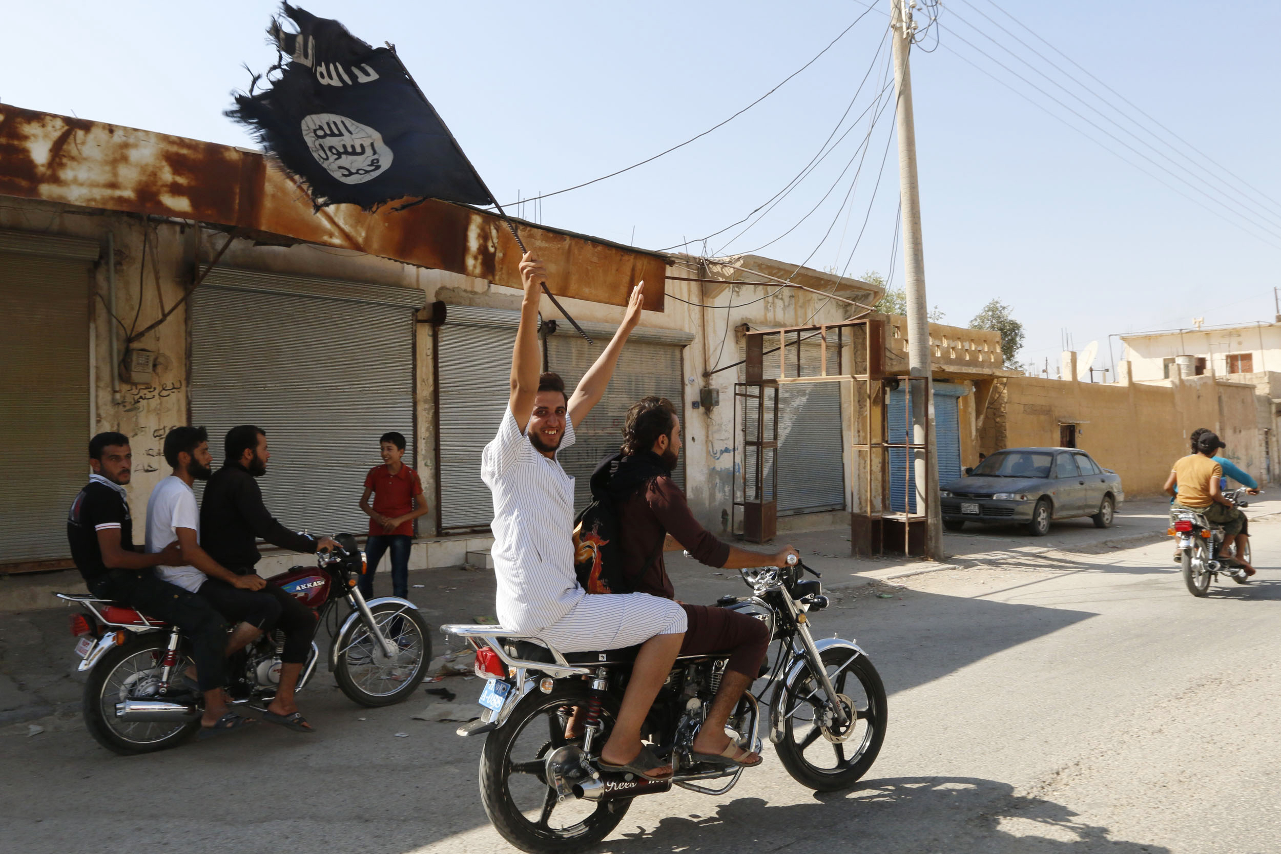 A resident of Tabqa city touring the streets on a motorcycle celebrates after Islamic State of Iraq and Greater Syria militants took over Tabqa air base, in the nearby Syrian city of Raqqa on  Aug. 24, 2014 (Reuters)